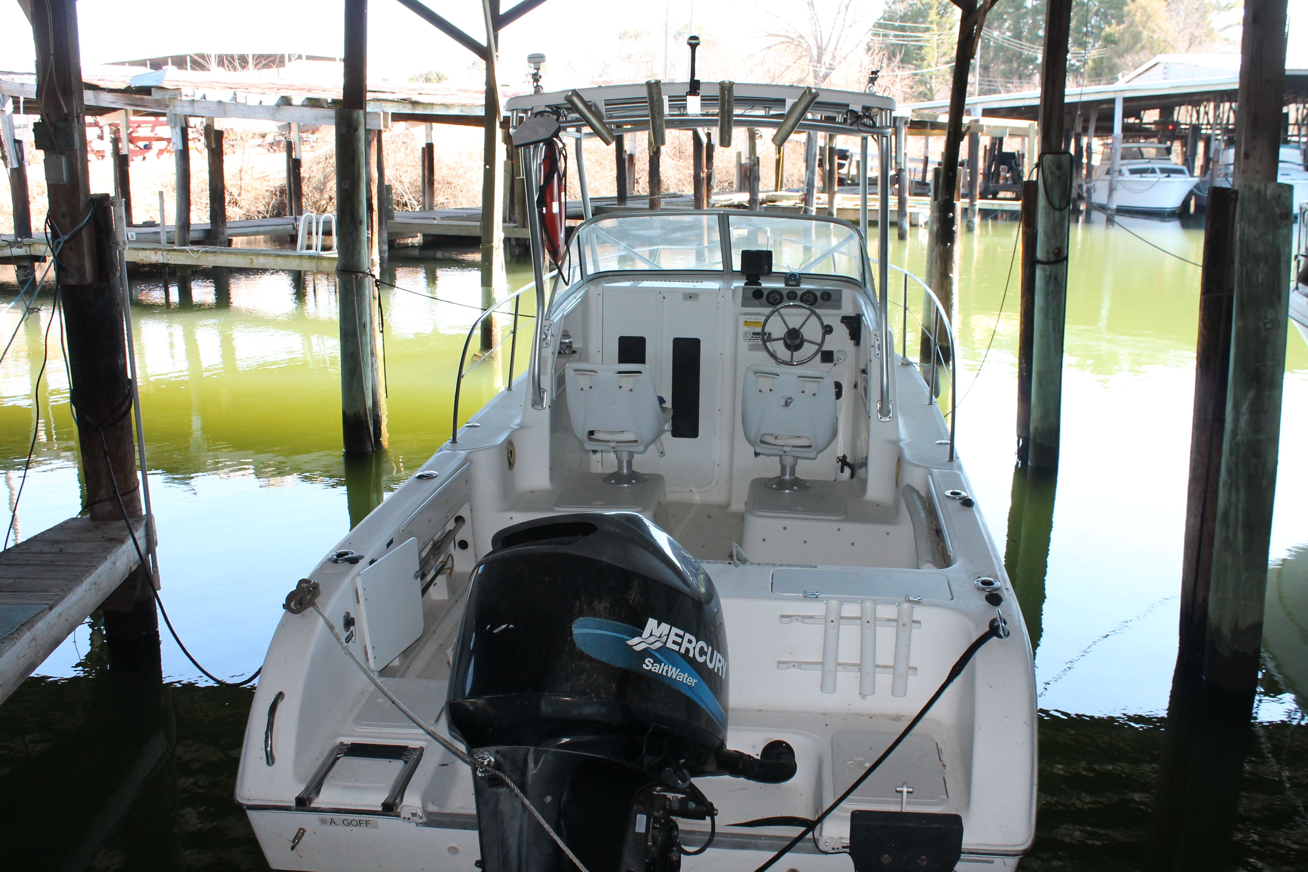 2004 Sea Fox 230 Walk Around boat docked in marina.