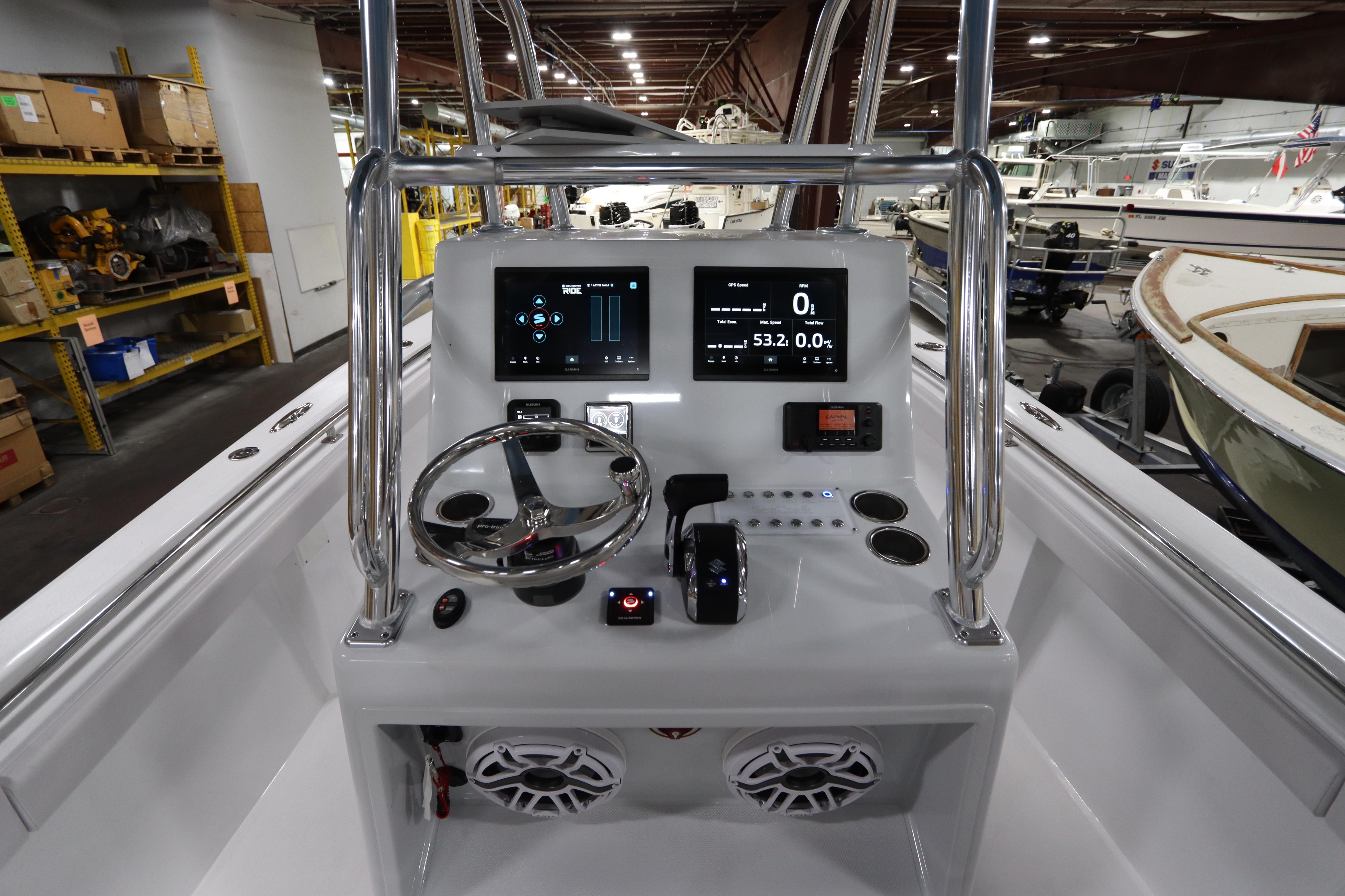 2024 SeaCraft 23CC boat console with modern controls and digital displays in a showroom.
