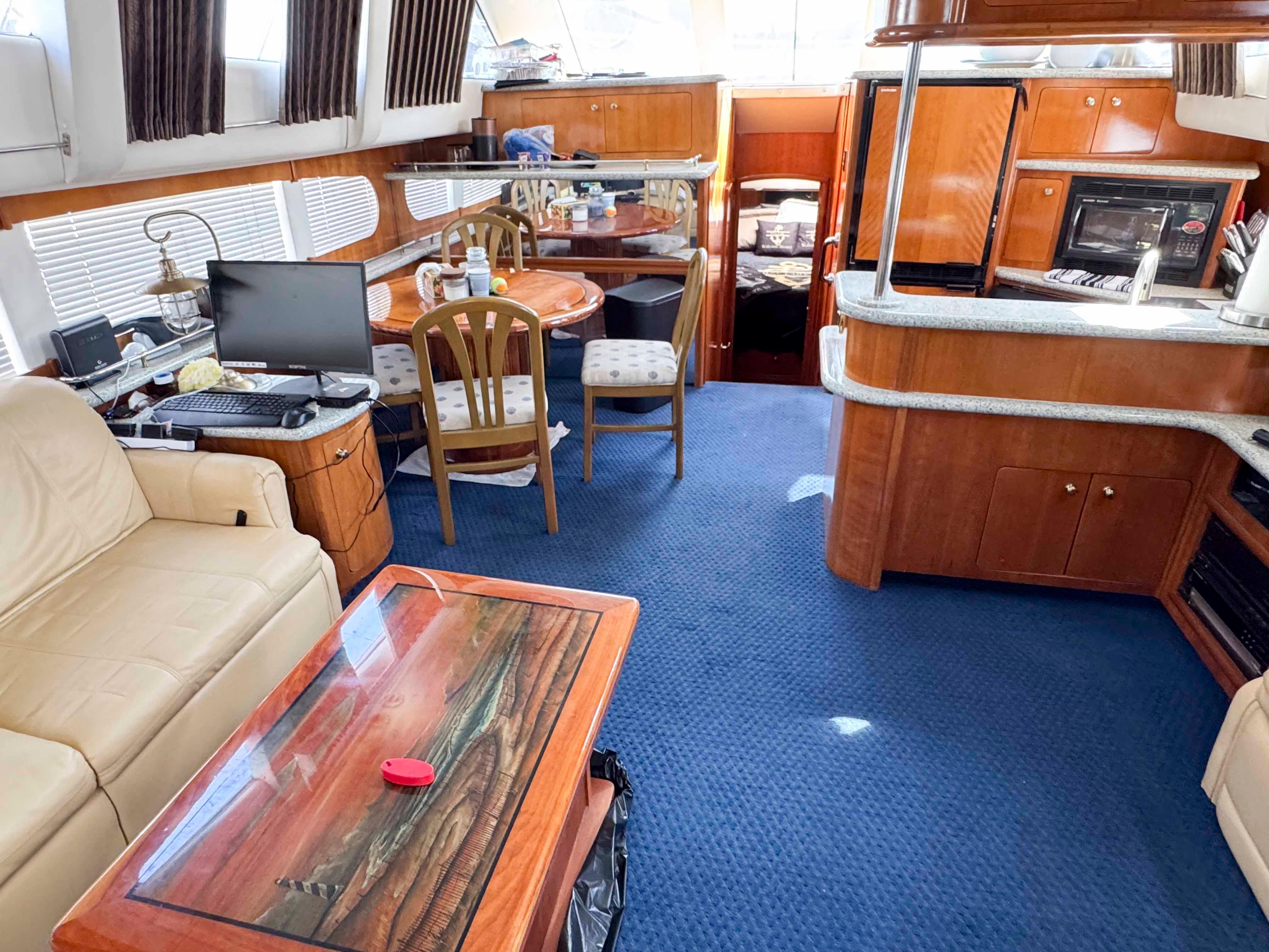 Interior of 2001 Carver 506 Motor Yacht with cozy seating and dining area.