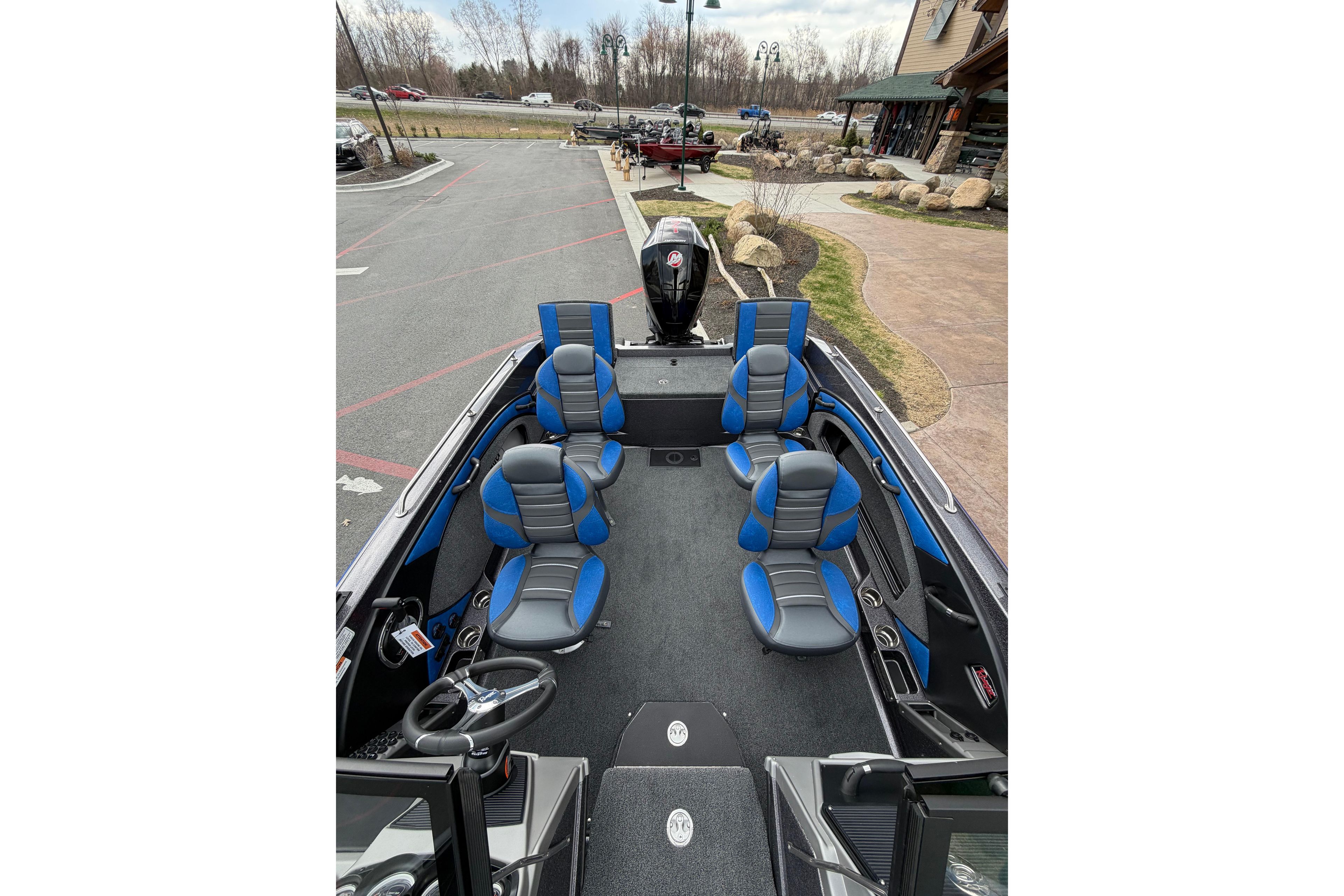2026 Ranger 1880MS boat interior with blue and gray seating, parked outdoors.