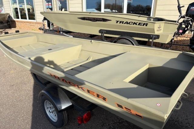 2026 Tracker Grizzly 15 Jon boat on trailer, displayed outdoors.