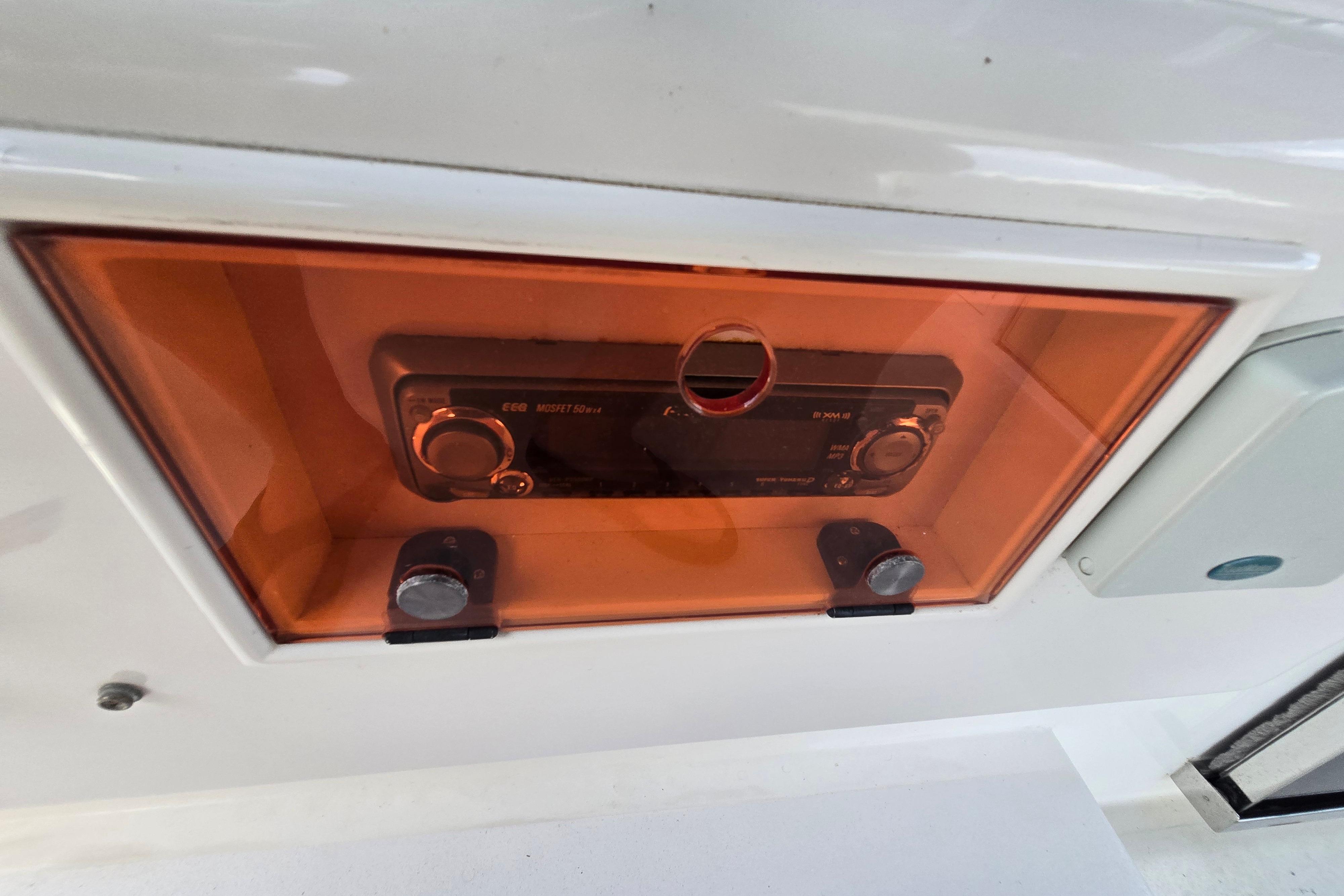 Stereo system in a 2004 Grand Harbour 58 boat, enclosed in an orange protective case.