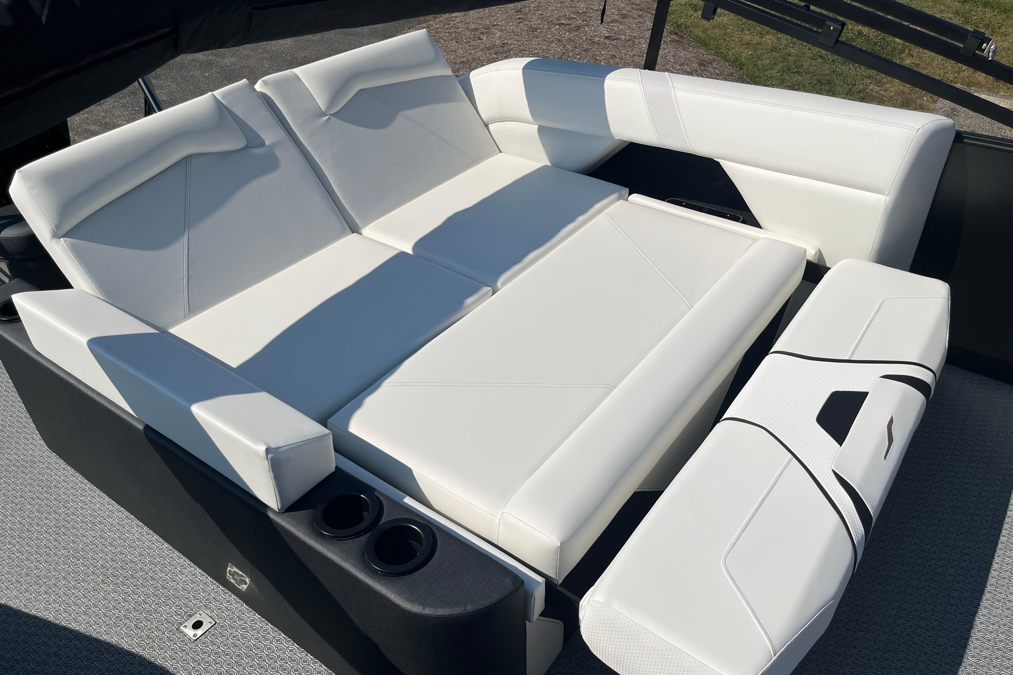 Luxurious white seating on 2026 Evotti 725CS boat, featuring modern design and cup holders.