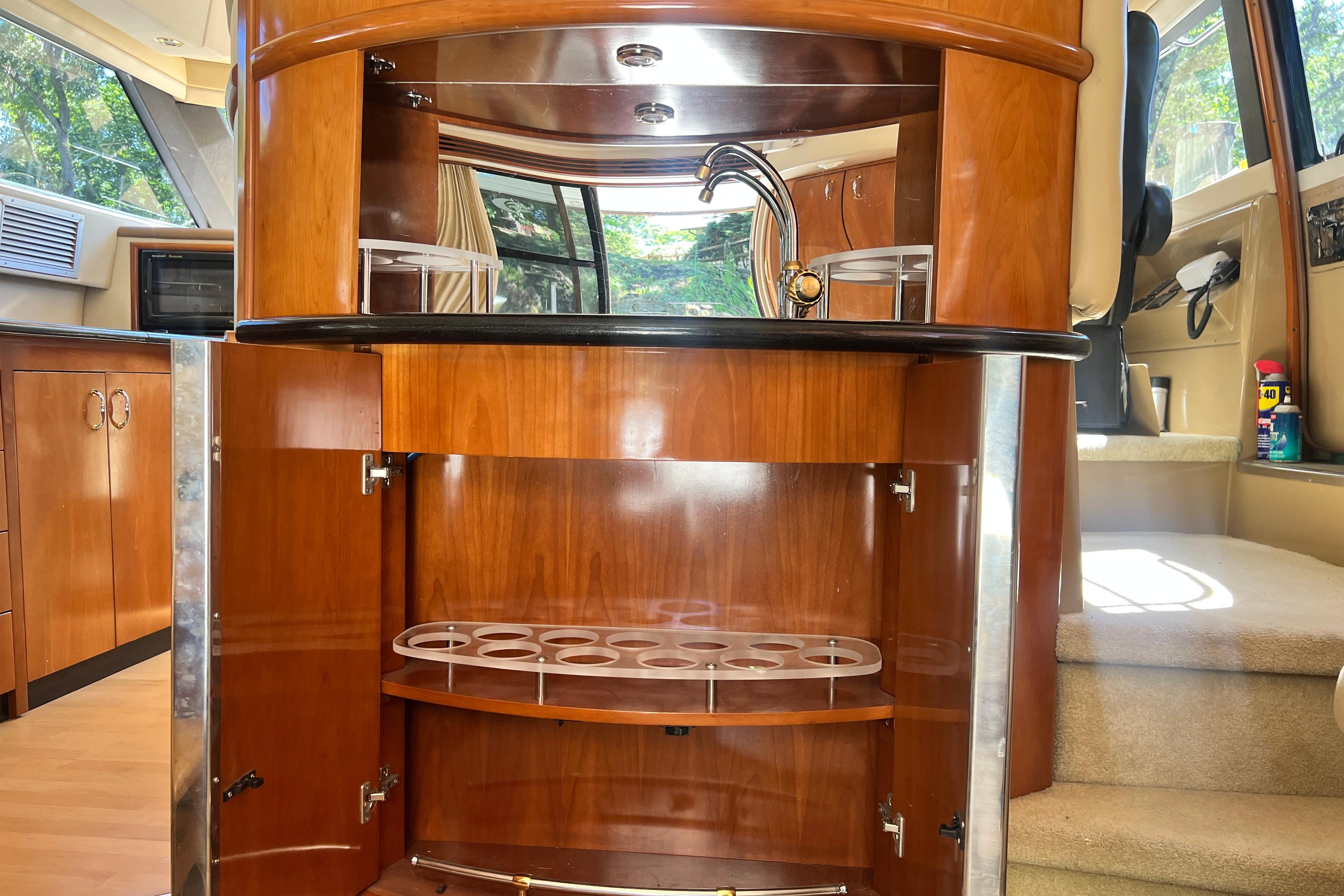 Interior of 2003 Carver 450 Voyager Pilothouse with wooden cabinetry and bar area.