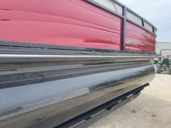 2023 Regency 250DL3 pontoon boat with red and black exterior on a trailer.
