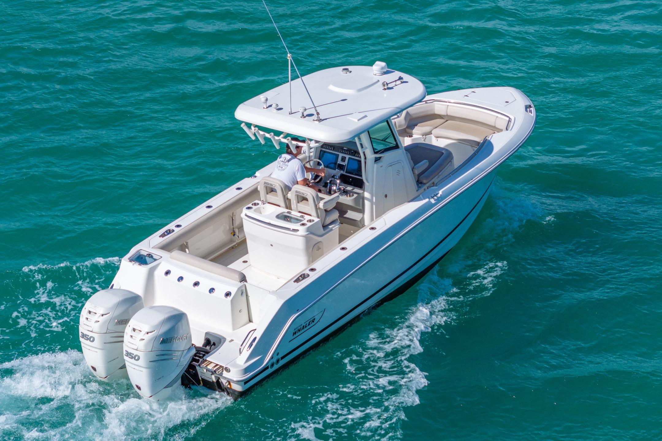 2016 Boston Whaler 280 Outrage cruising on clear blue water.