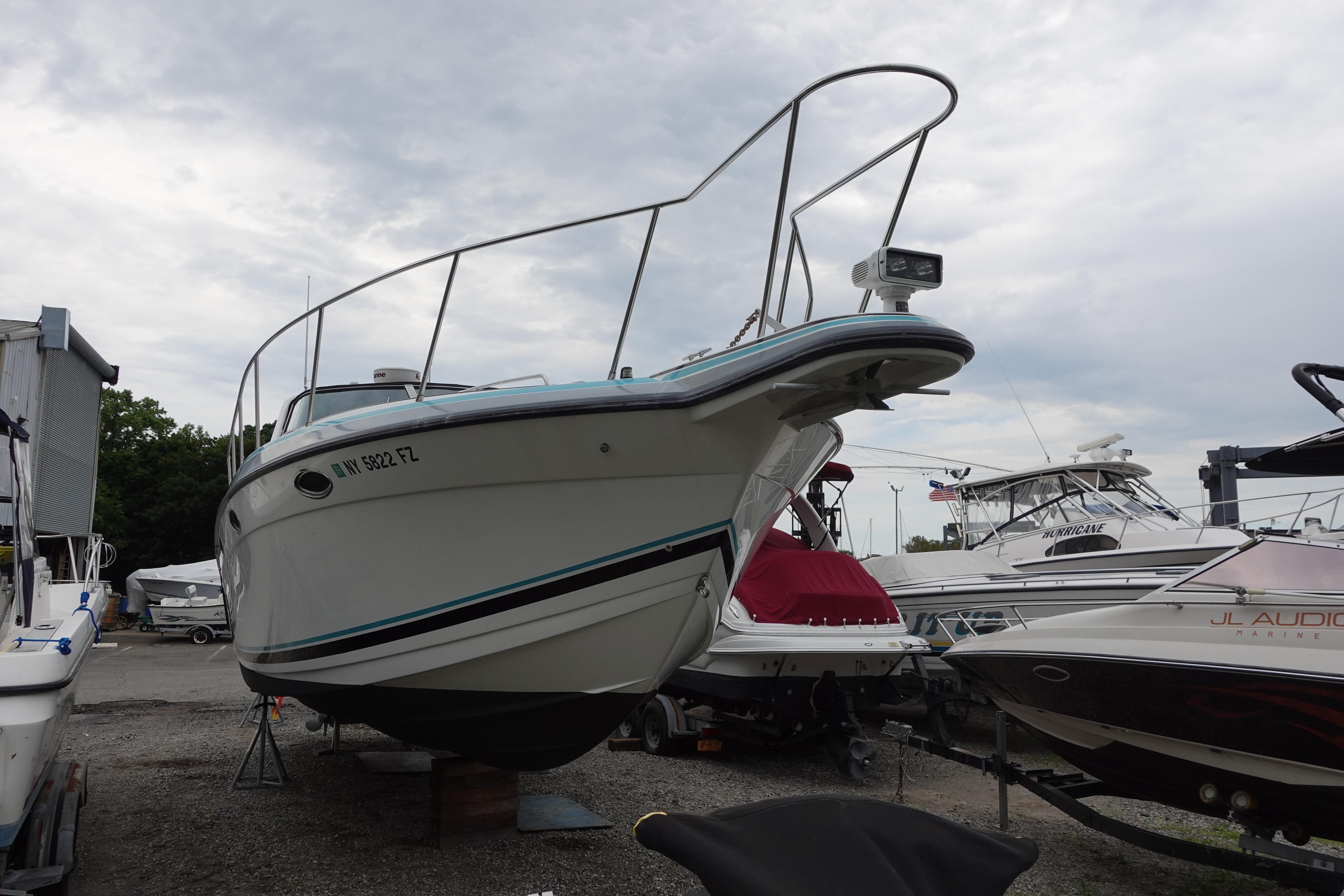1993 Formula 34 Performance Cruiser boat on dry dock, surrounded by other vessels.