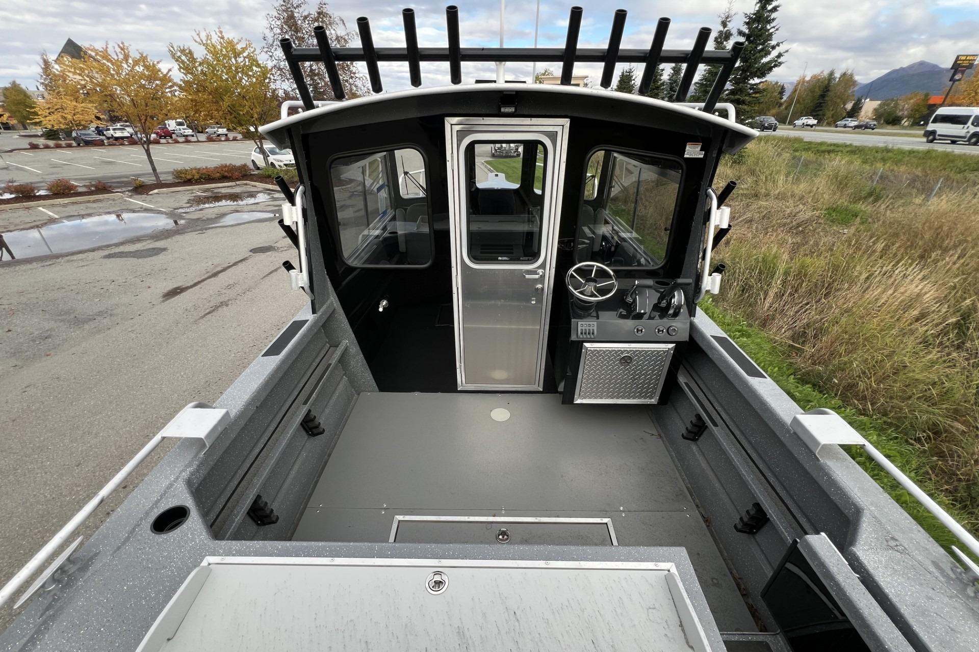 2024 Spartan 220 Maximus boat interior with steering wheel and control panel.