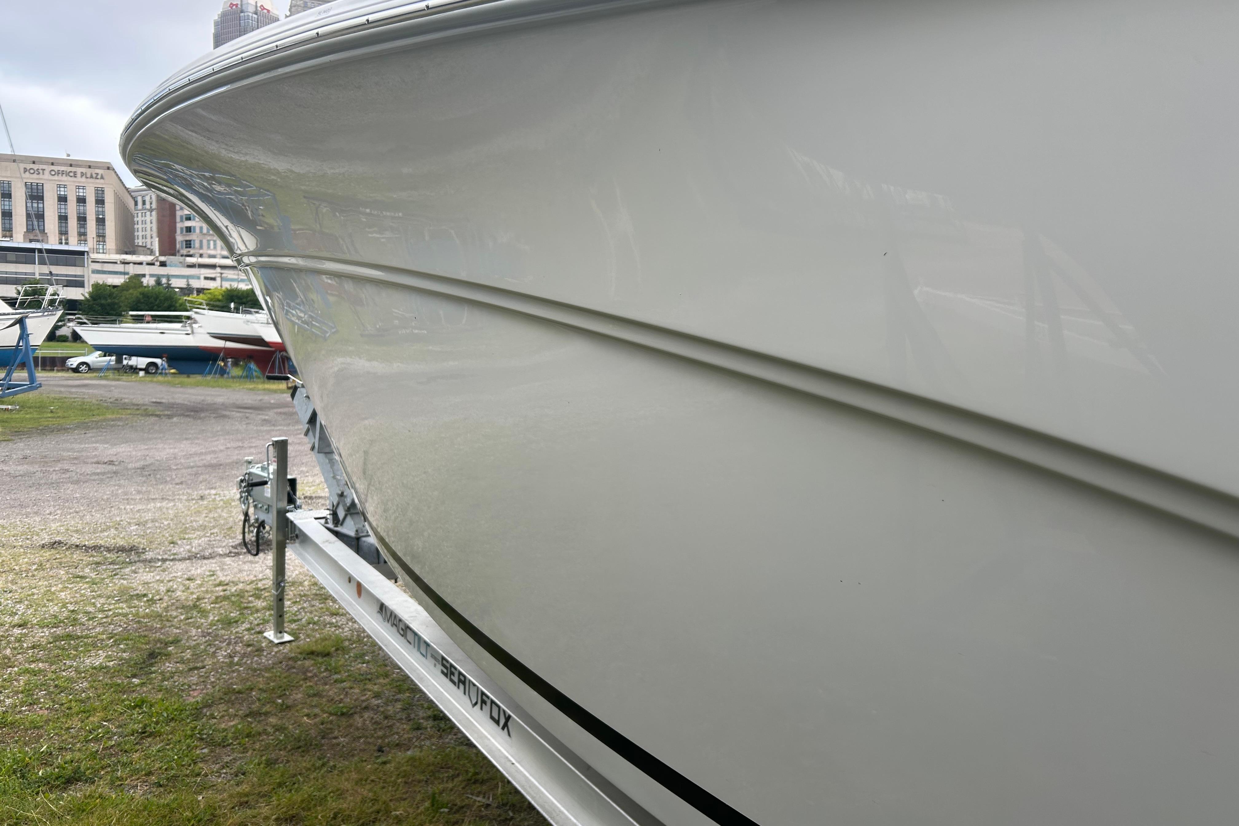 2026 Sea Fox 268 Commander boat on trailer, side view in marina setting.