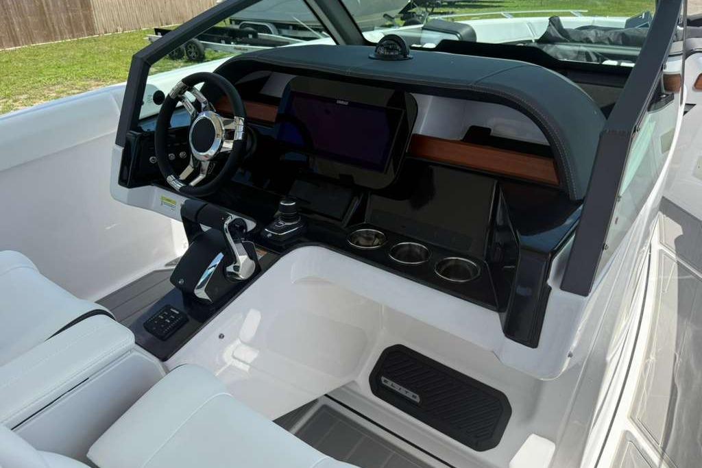 2026 Monterey Elite 30 OB boat cockpit with modern steering and control panel.