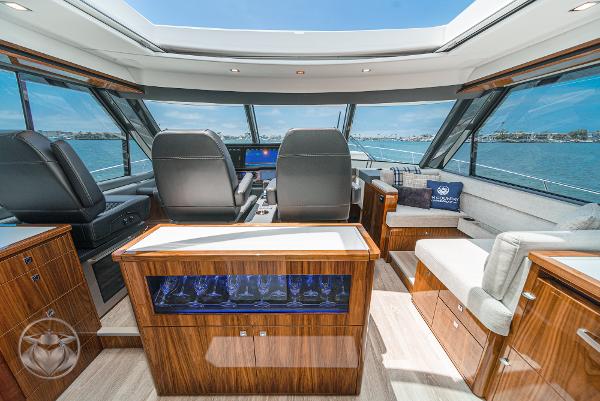 2025 Riviera 645 SUV yacht interior with luxurious seating and panoramic windows.