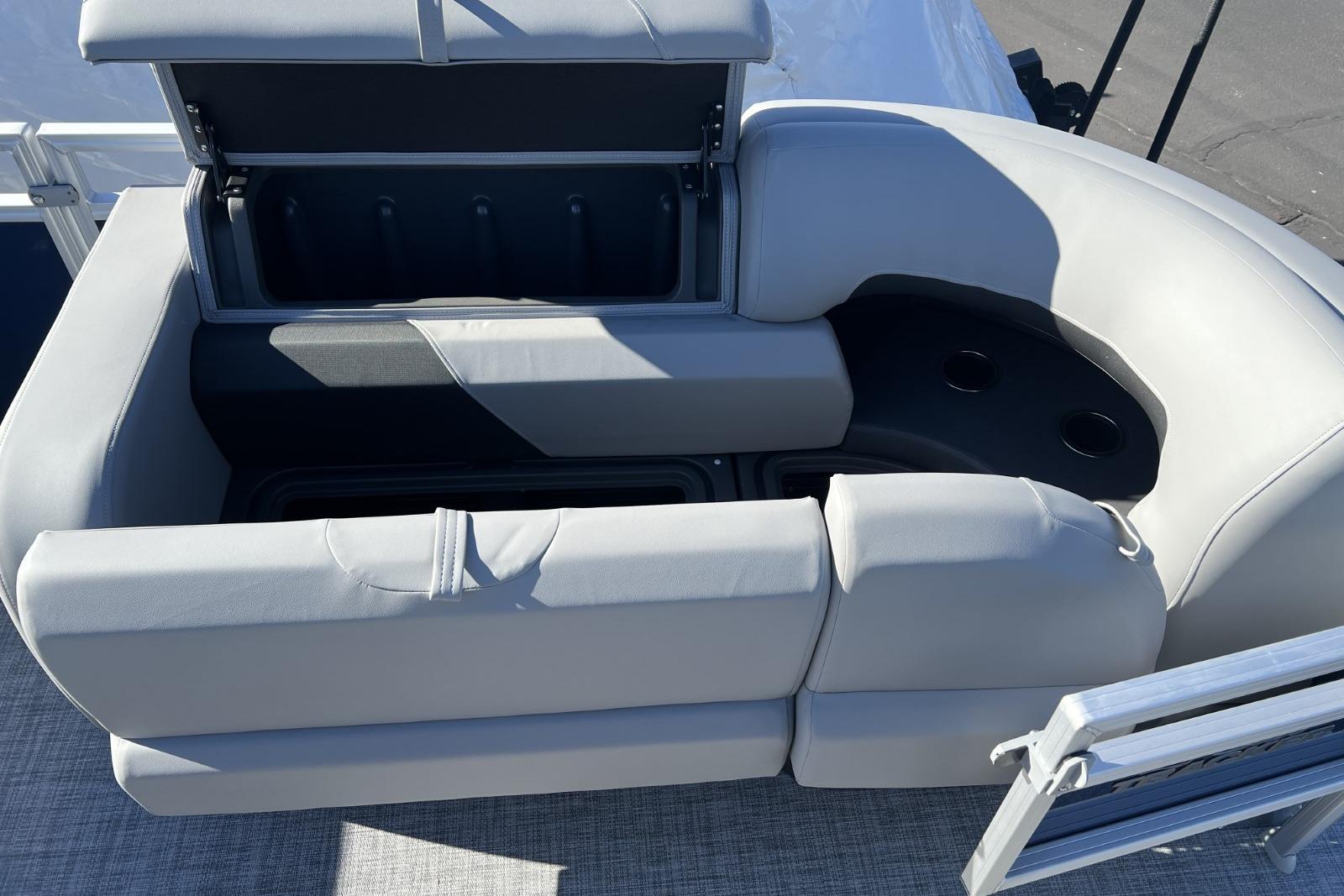 2026 Sun Tracker SportFish 22 DLX boat seating with storage and cup holders.