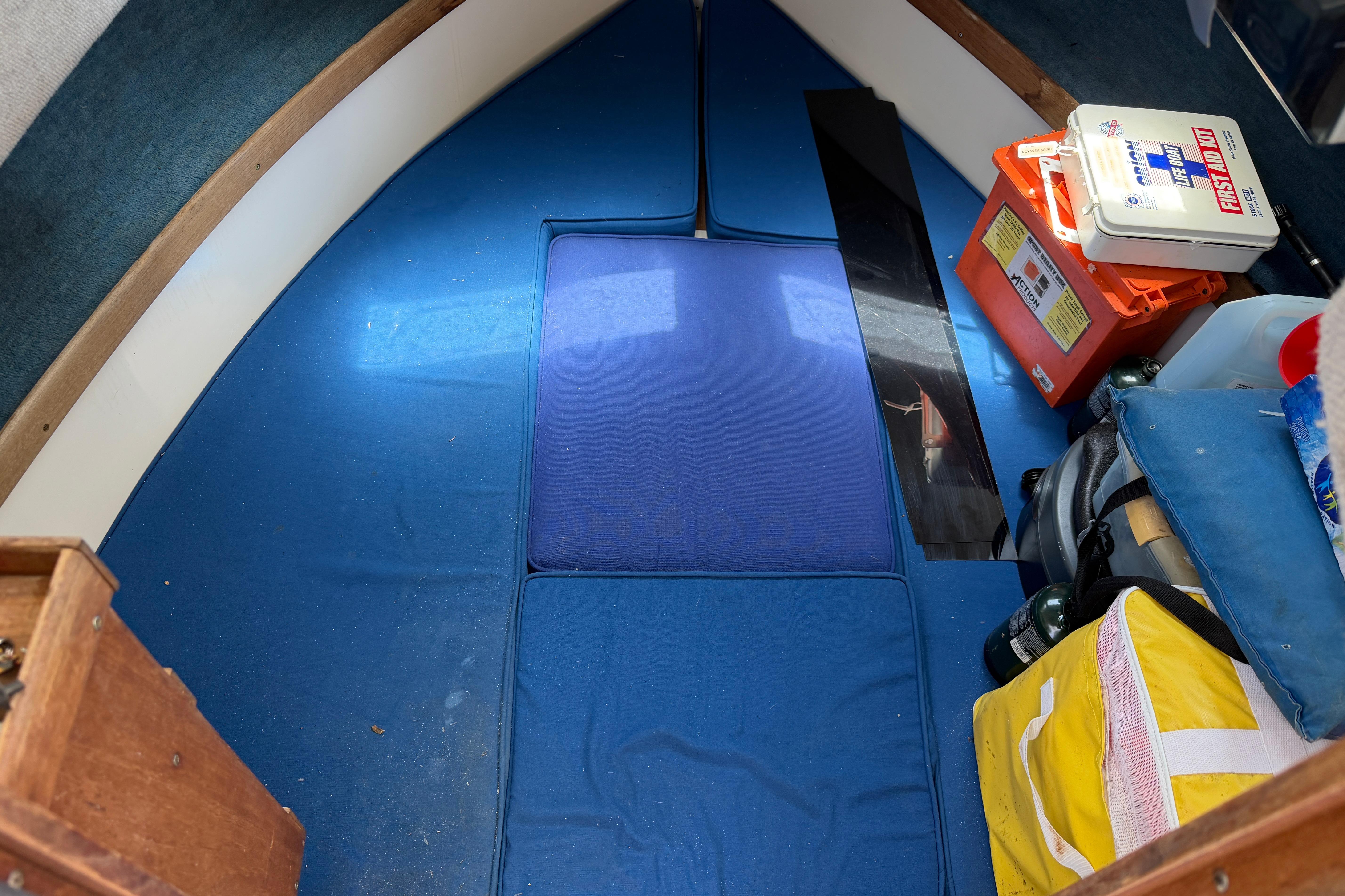 Interior cabin of 1987 Grady-White Seafarer 226 with blue cushions and safety equipment.