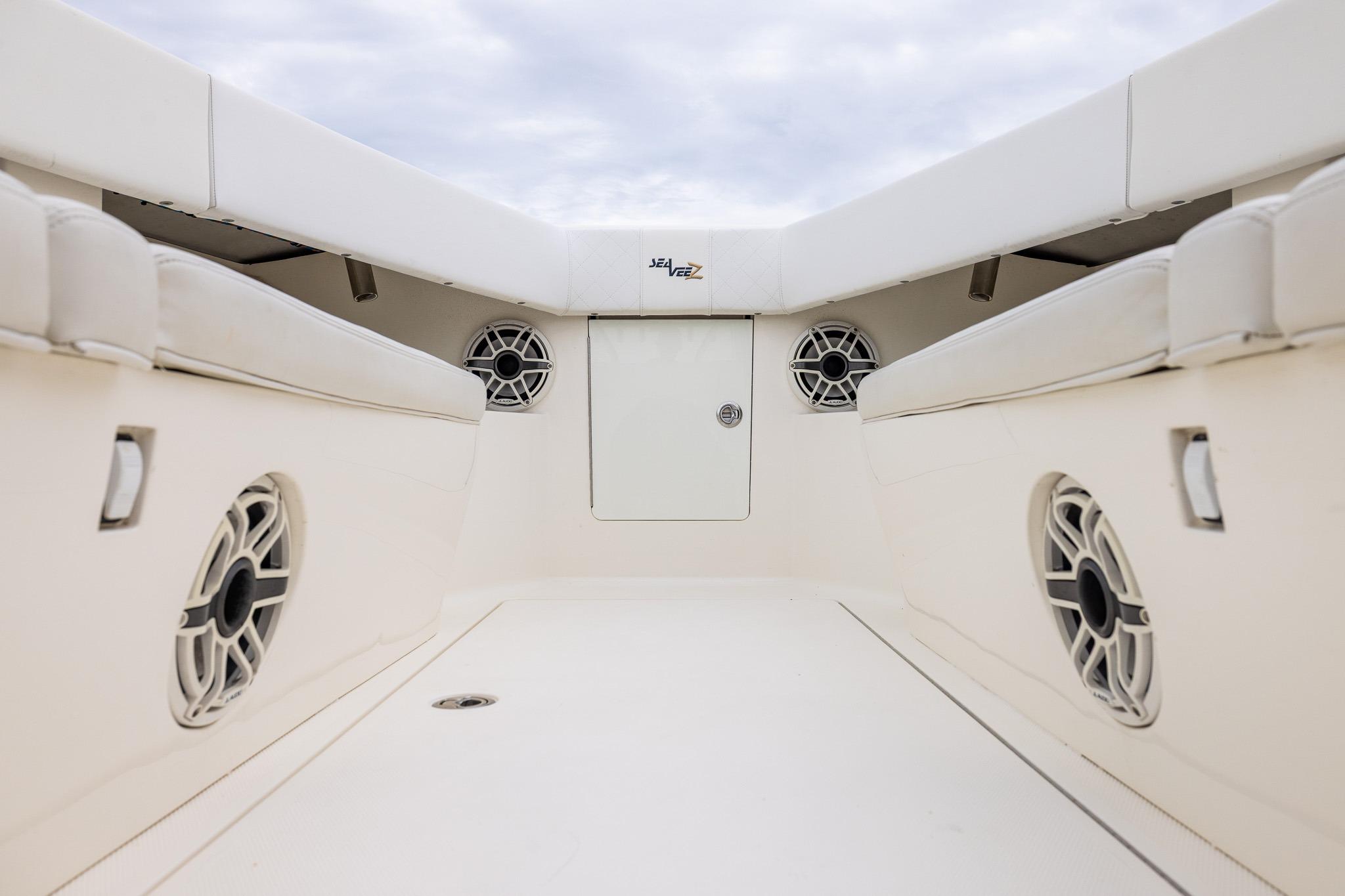 2019 SeaVee 322Z boat interior with cushioned seating and built-in speakers.