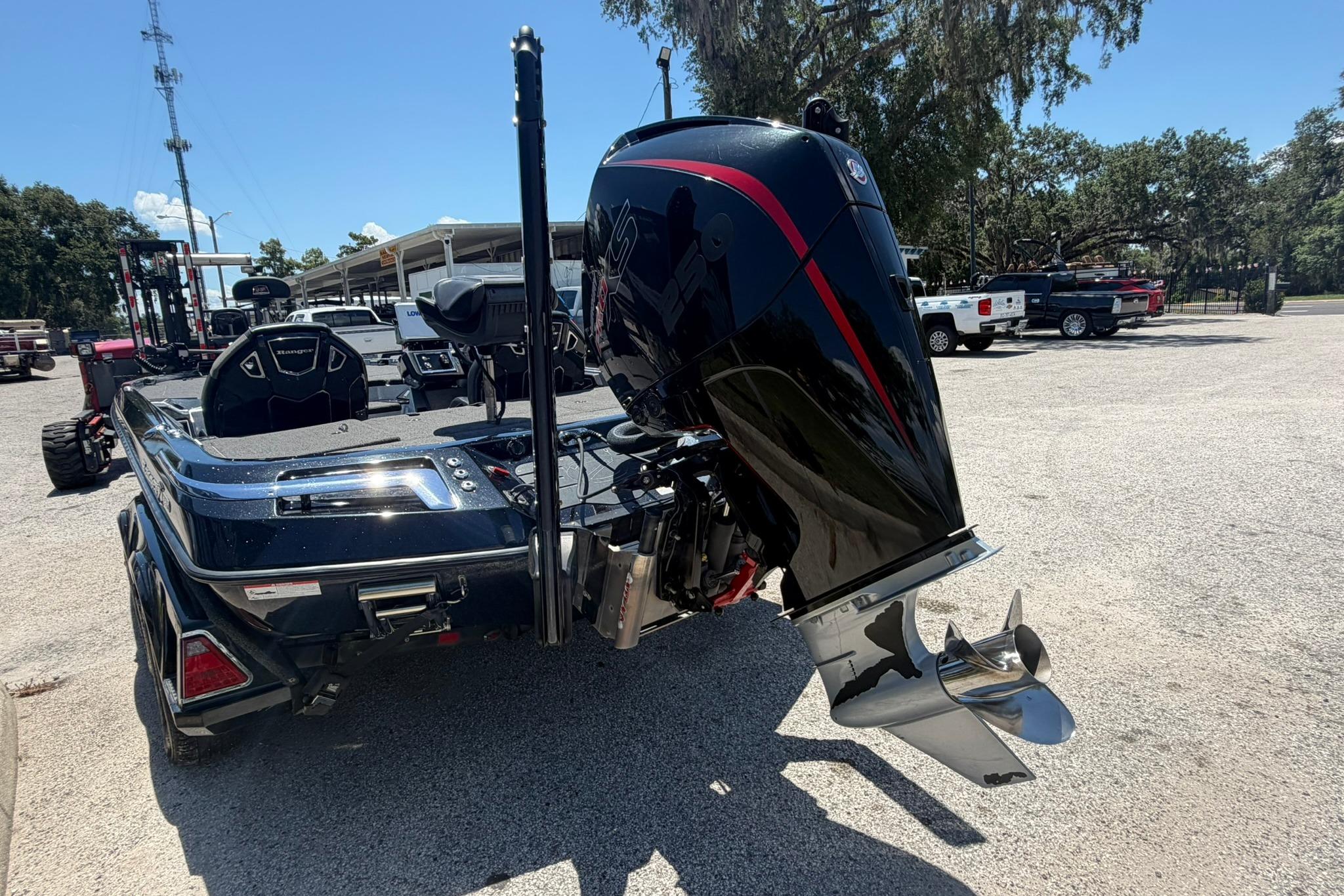 2023 Ranger Z521R boat with powerful outboard motor, parked outdoors on a sunny day.