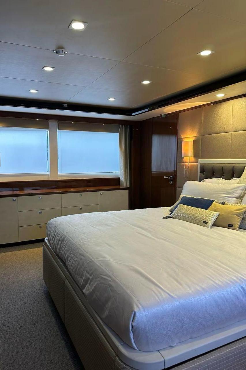 Luxurious bedroom interior on 2013 Princess M Class 32M yacht, featuring elegant decor and ambient lighting.