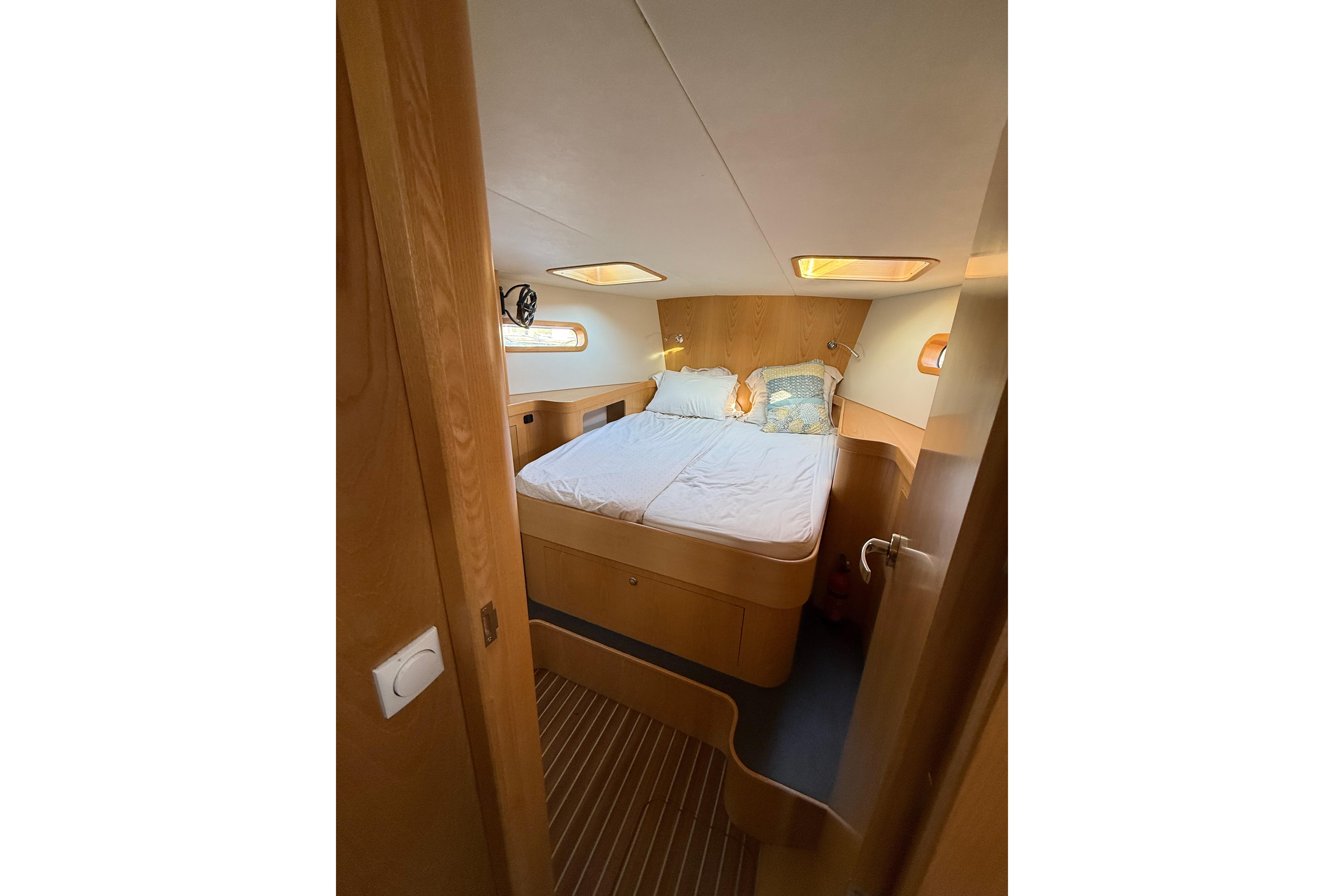 Cozy cabin interior of 2017 Boreal 47 yacht with double bed and wooden finish.
