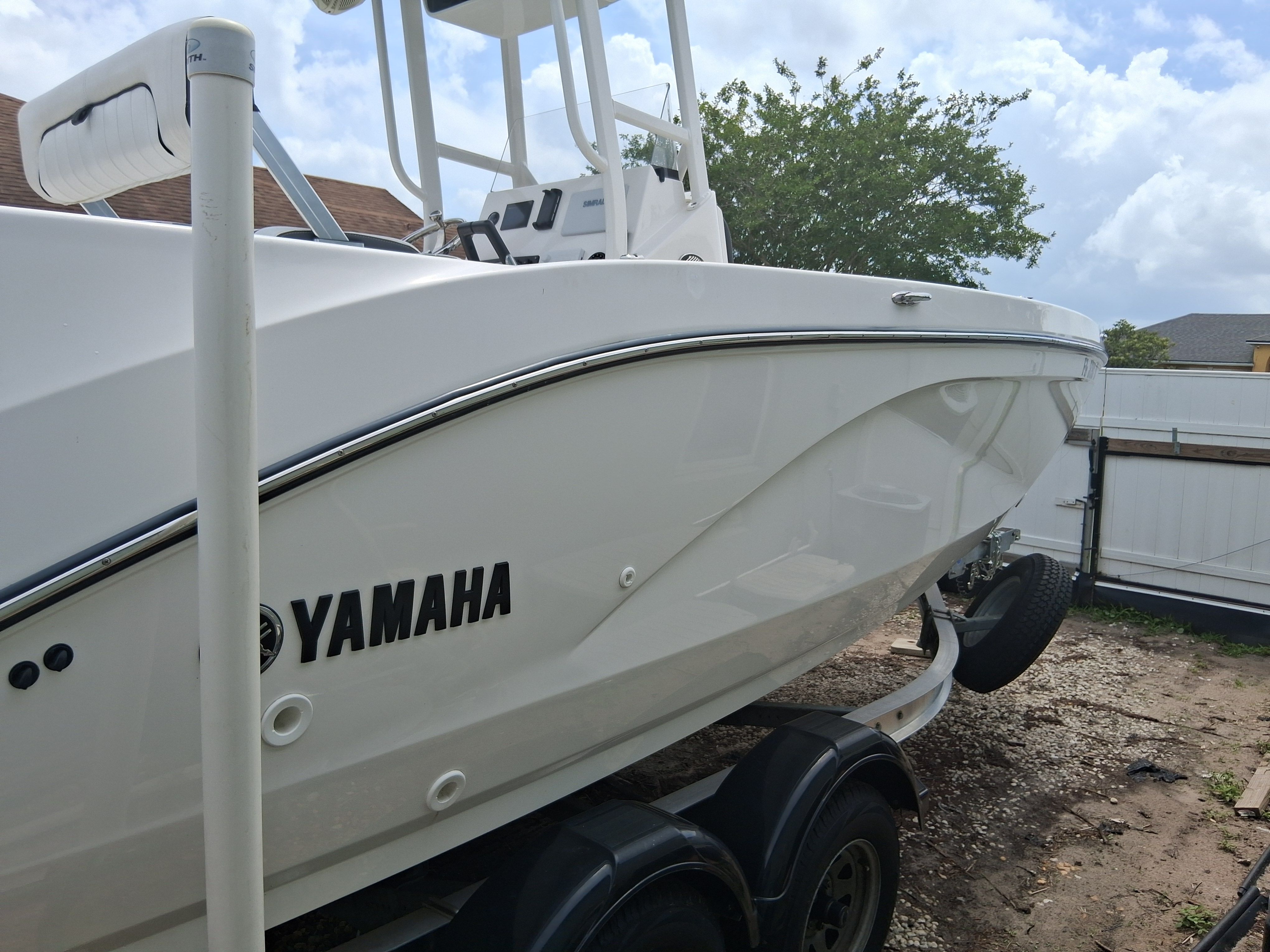 A white Yamaha boat on a trailer, ready for use on the water.
