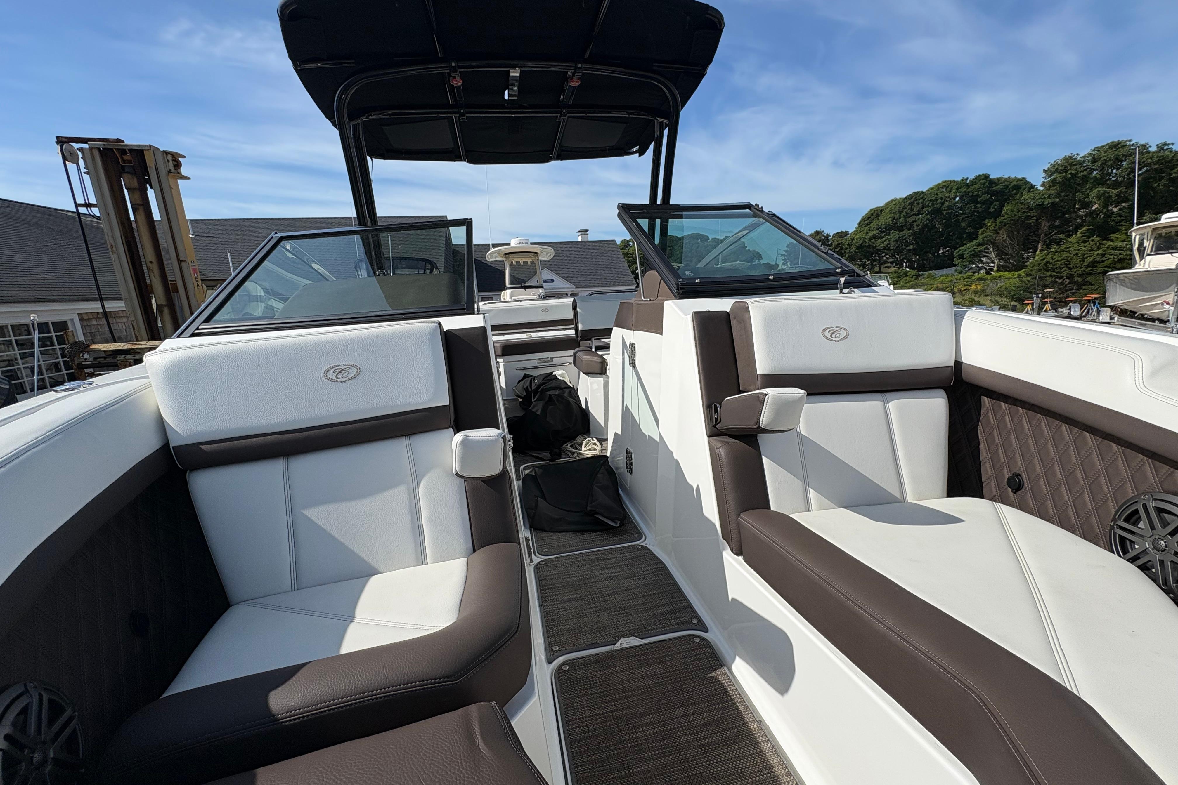 2022 Cobalt R6 boat interior with white and brown seating, open deck, and clear skies.