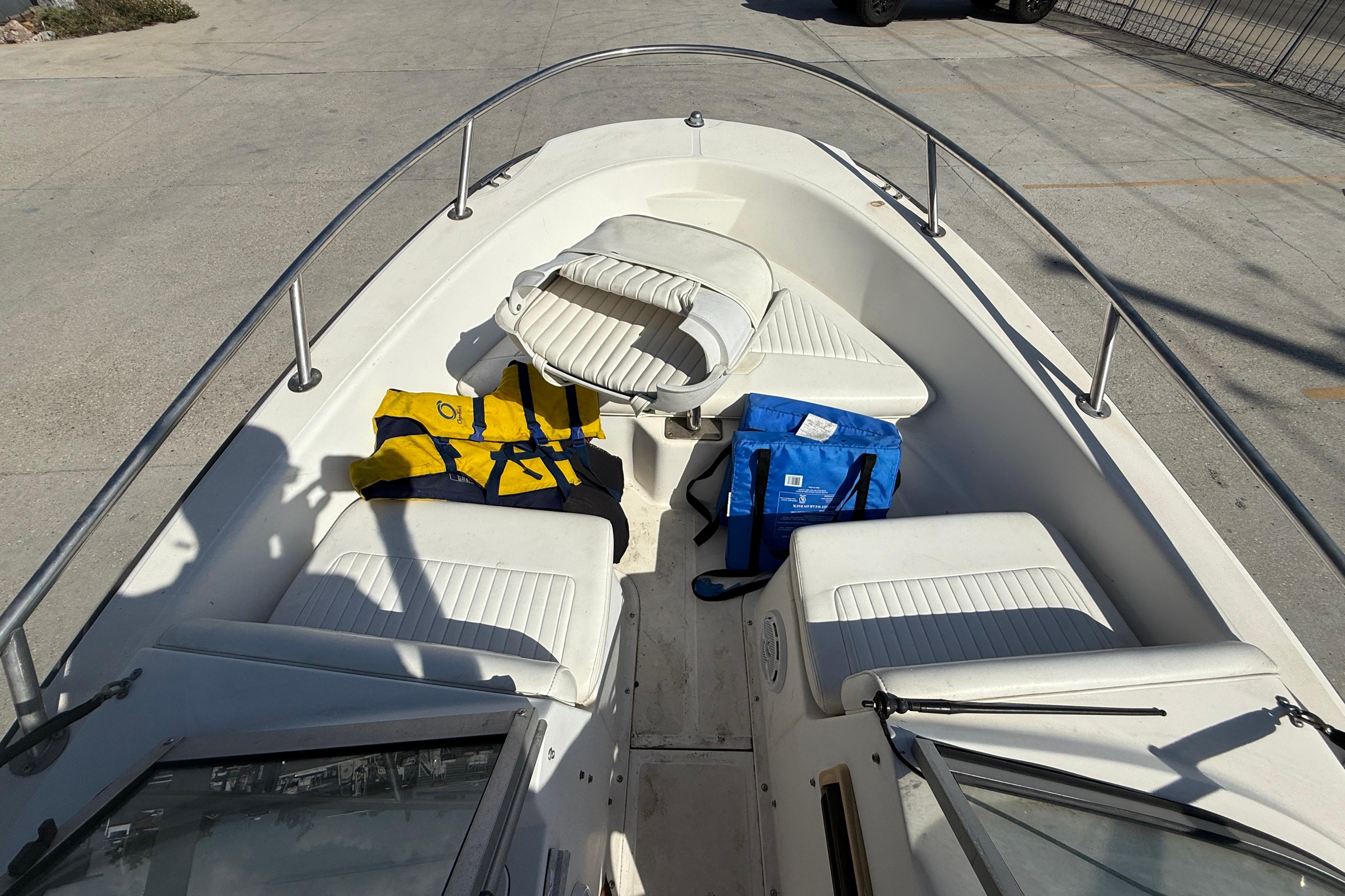 2002 Boston Whaler Ventura 160 boat interior with life jackets and seating.