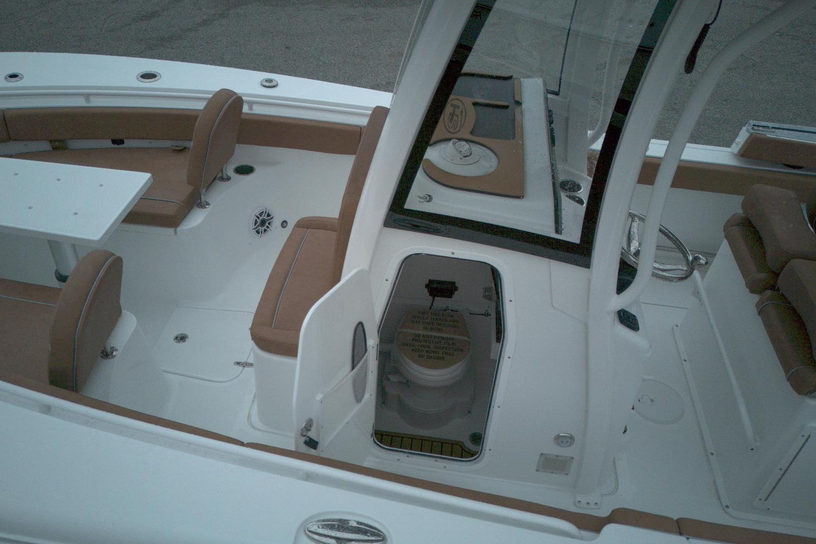 2026 Sea Hunt Gamefish 25 interior with seating and open hatch.