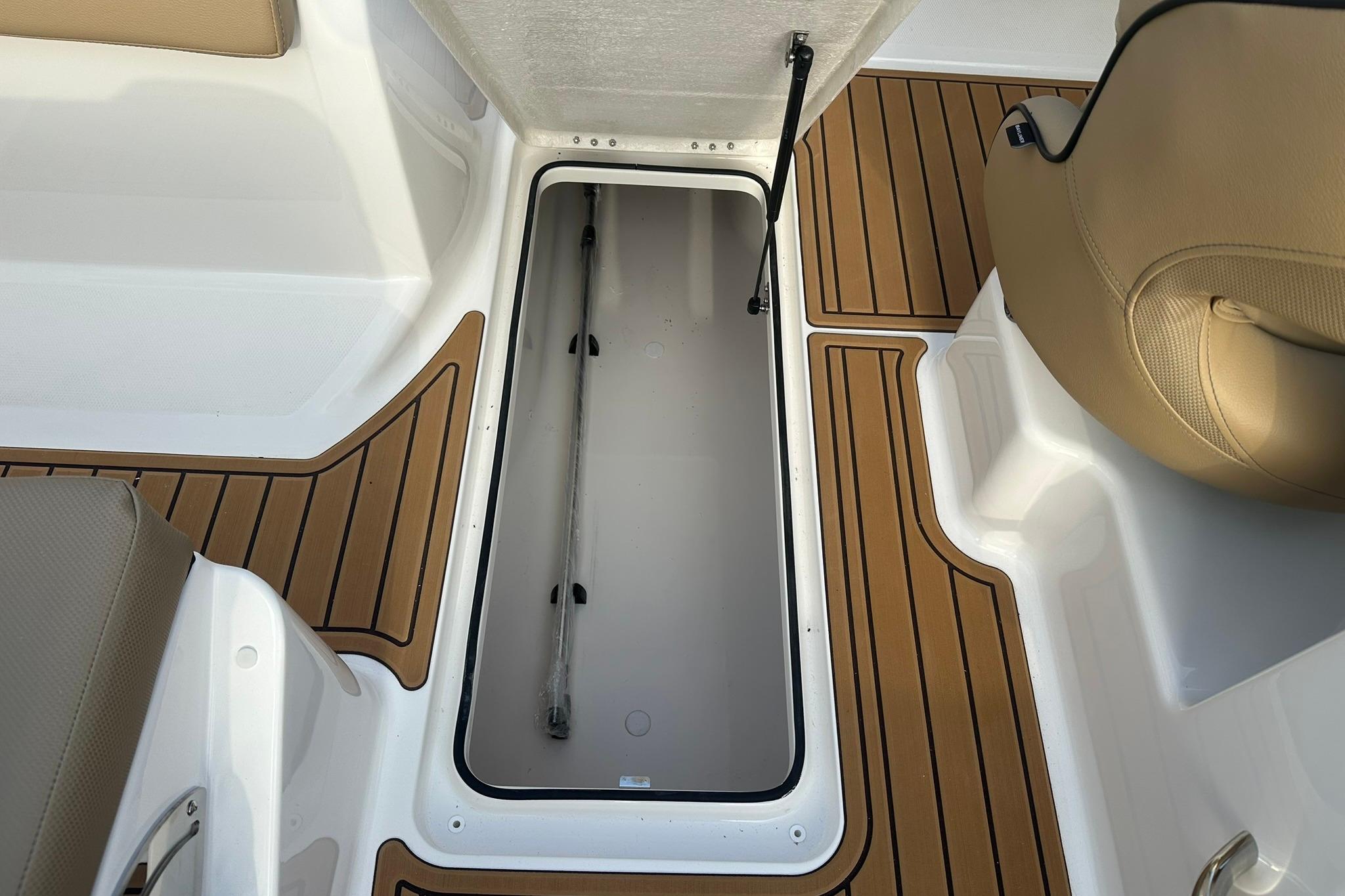 2026 Bayliner VR6 Bowrider OB interior storage compartment with teak-style flooring.