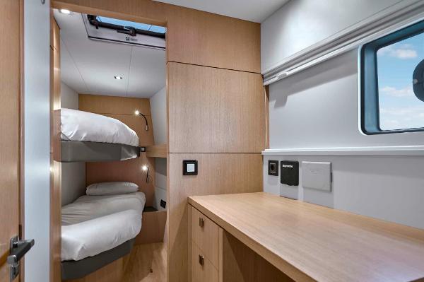 2025 Privilege Signature 580 cabin with bunk beds and wooden interior design.