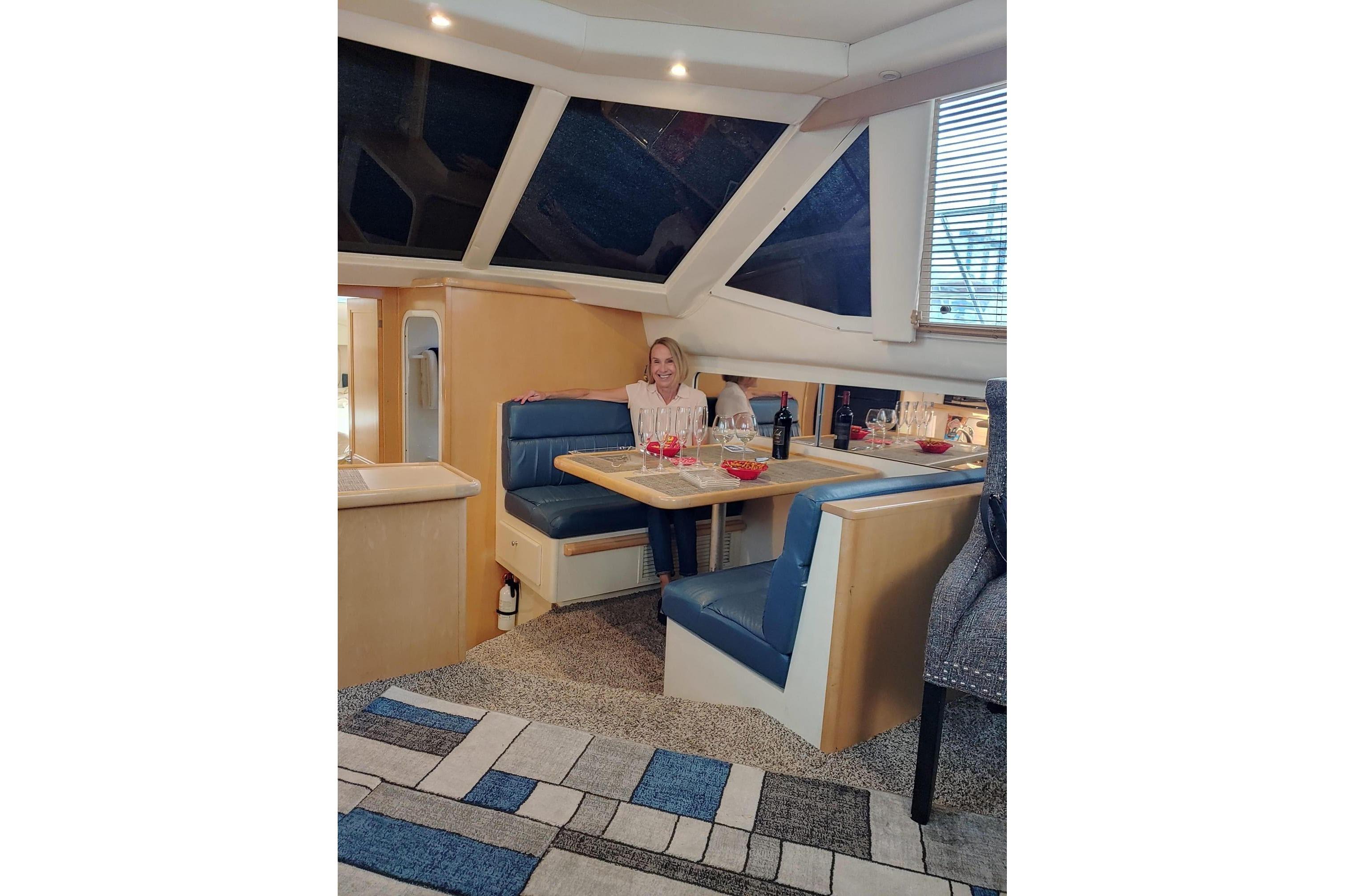 Interior of 1998 Carver 355 Aft Cabin Motor Yacht with dining area and seating.
