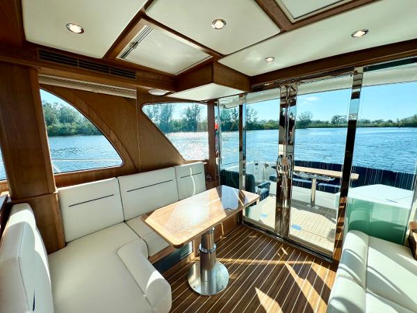 Interior of 2025 Sabre 43 Salon Express yacht with elegant seating and scenic water view.