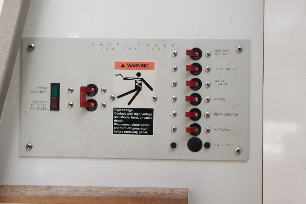 Control panel of 1999 Maxum 2400 Mercruiser with warning sign.