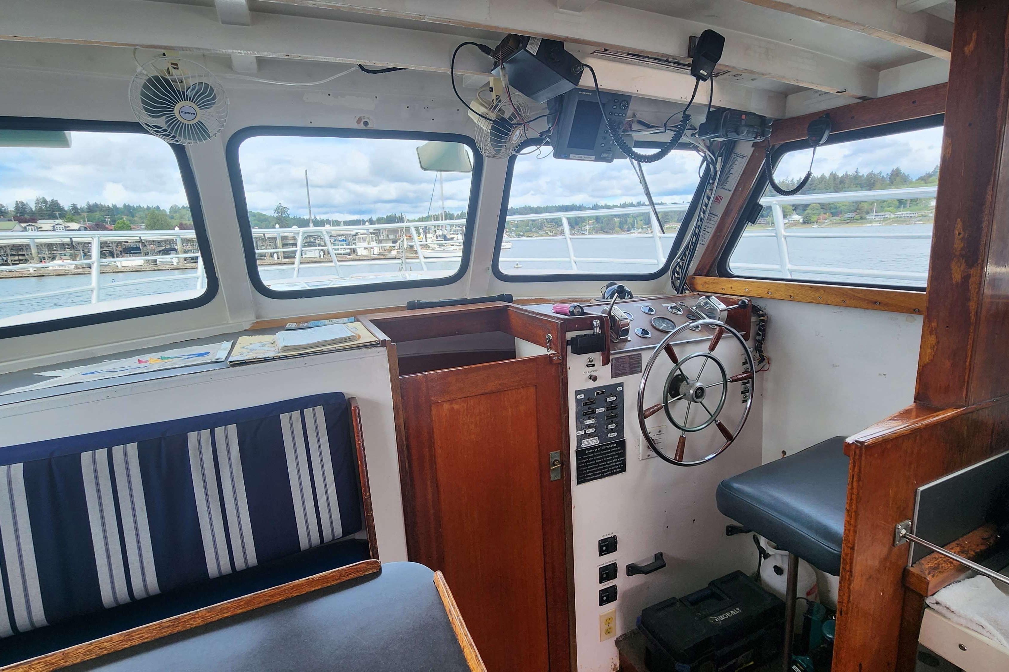Interior of a 1964 Grandy Tour Boat with steering wheel and seating.