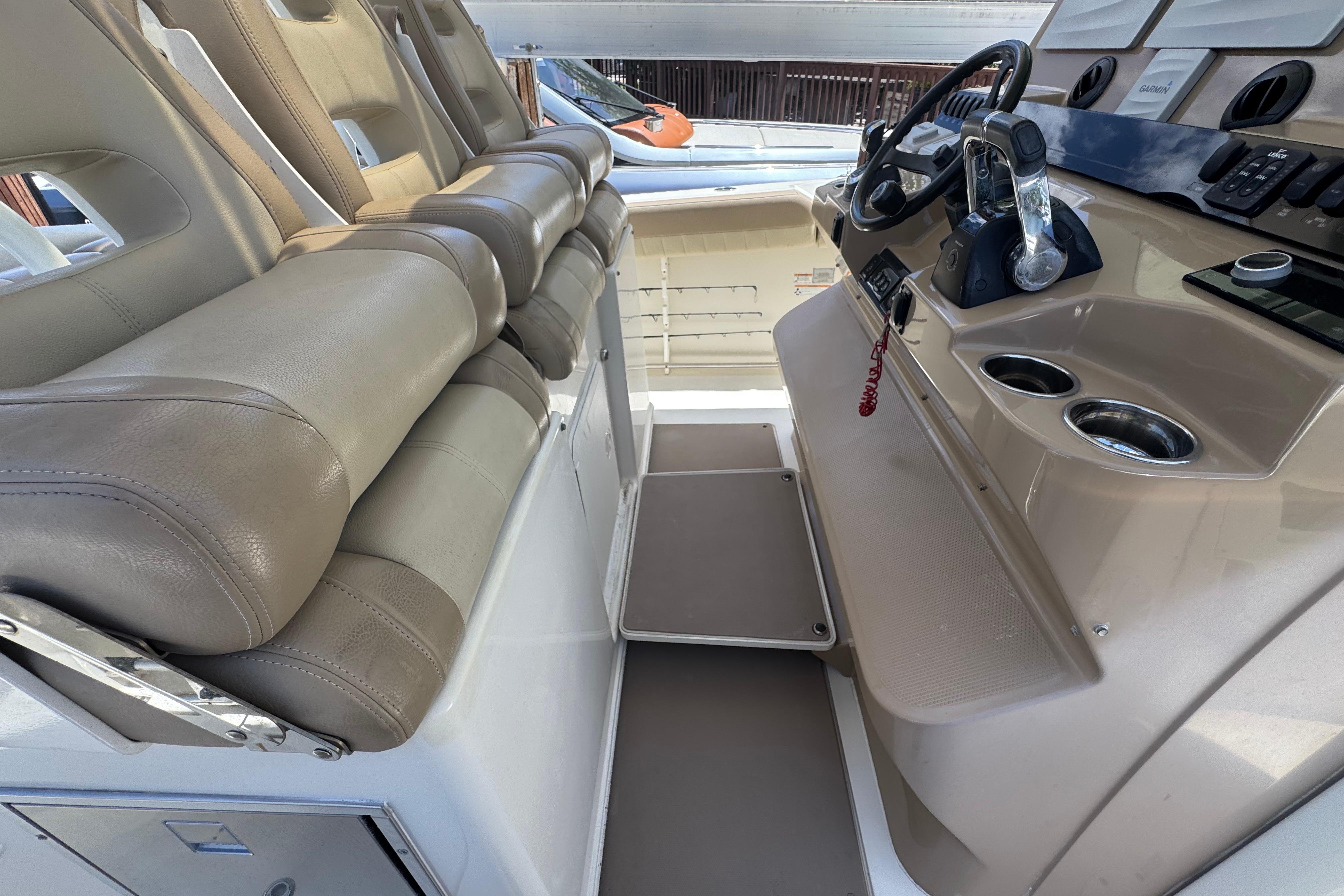 Interior of a 2019 Sailfish 360 CC boat featuring beige seating and a modern helm.