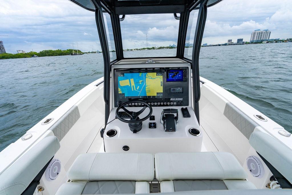 Cockpit view of 2027 Reef Runner 280 boat with navigation system on open water.