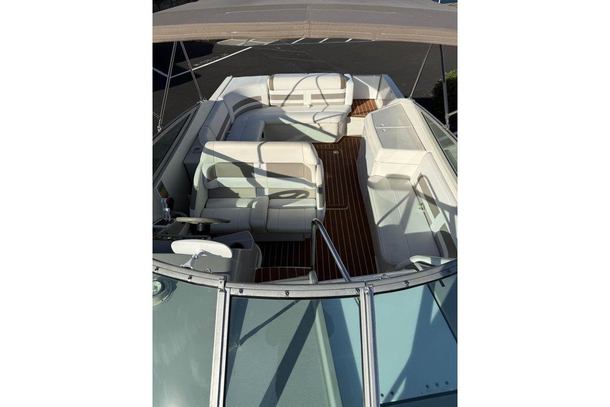 1999 Formula 280 Sun Sport boat interior with white seating and wooden flooring.