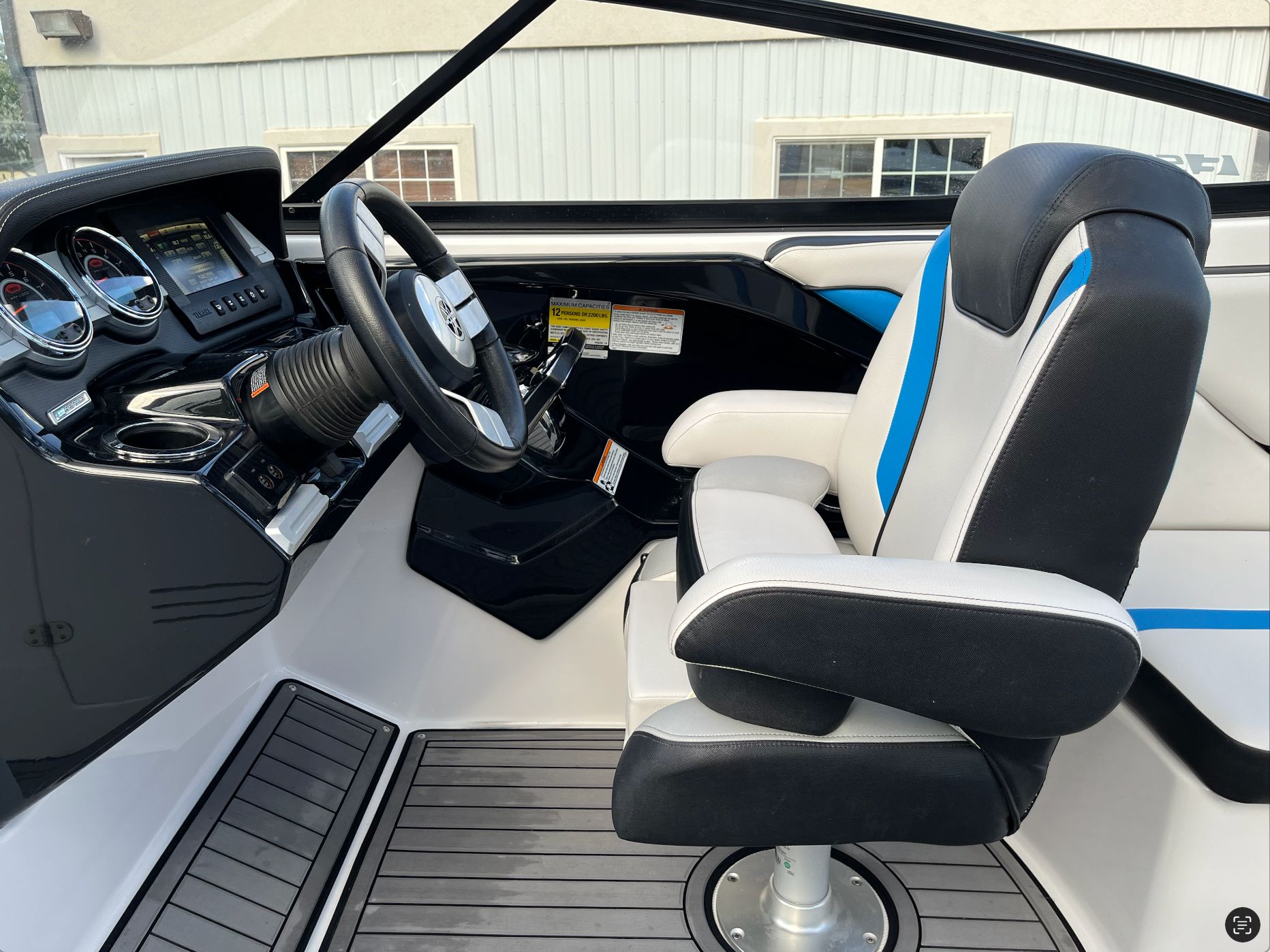 Interior of a 2017 Yamaha Boats 242X E-Series with steering console.