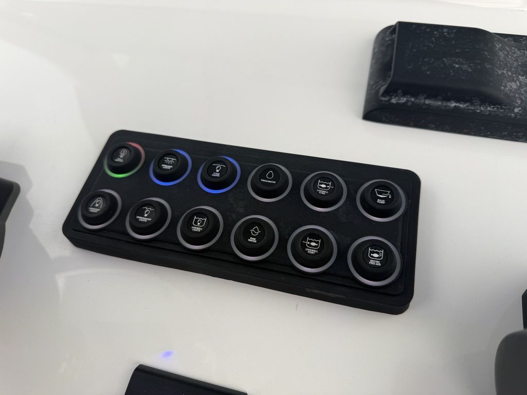 Control panel with various buttons on a boat.
