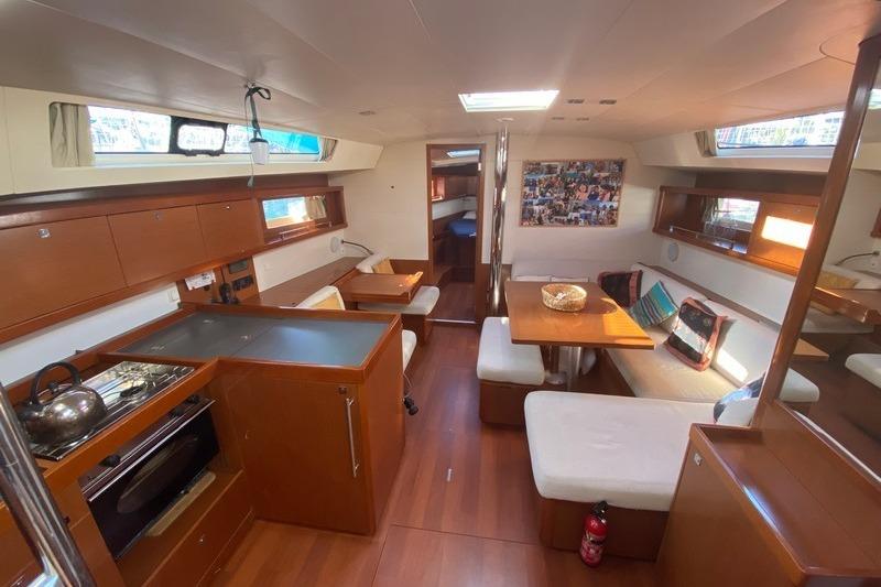 Interior of 2012 Beneteau Oceanis 45 yacht with modern kitchen and cozy seating area.