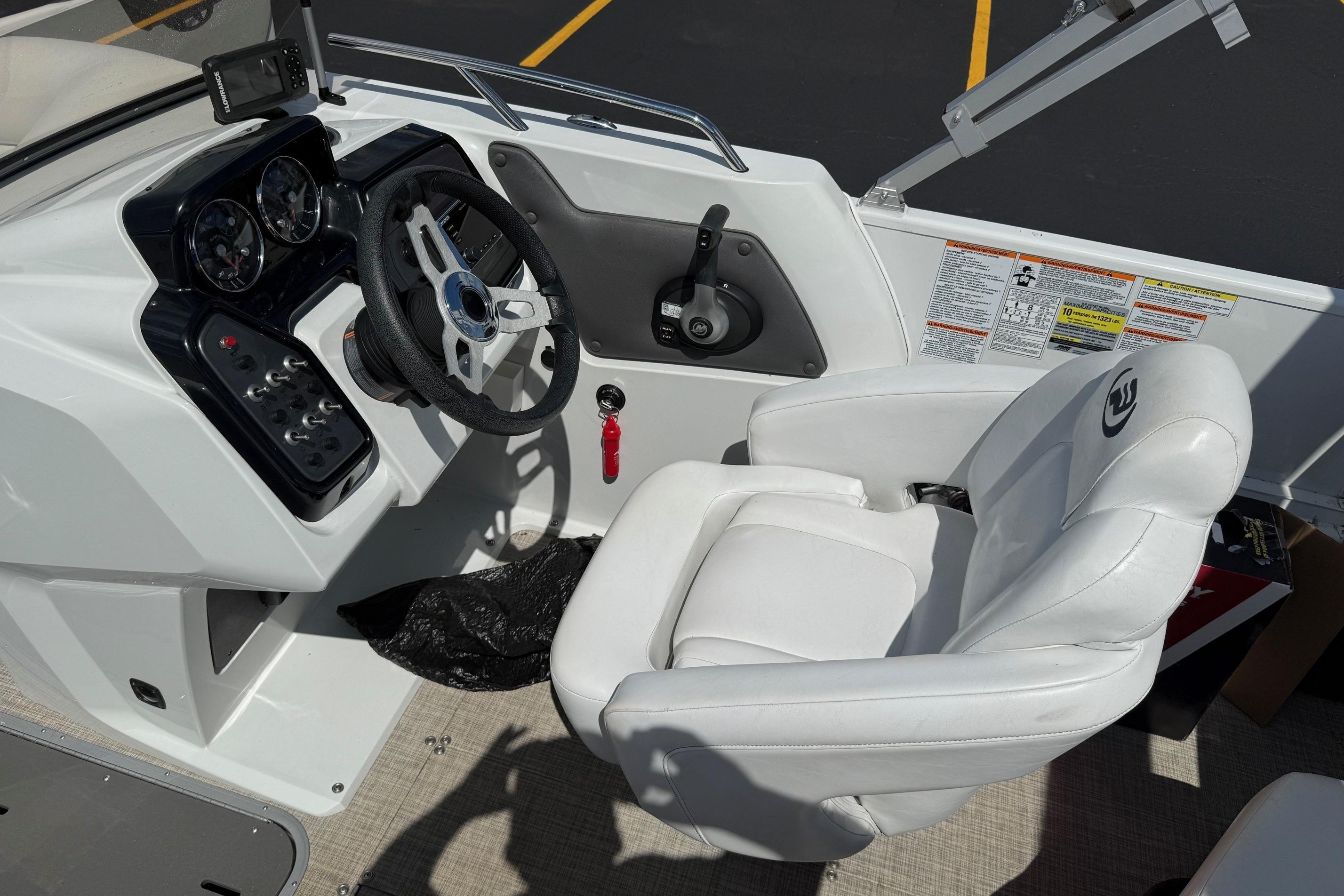 2019 Princecraft Ventura 190 boat cockpit with steering wheel and white captain's chair.