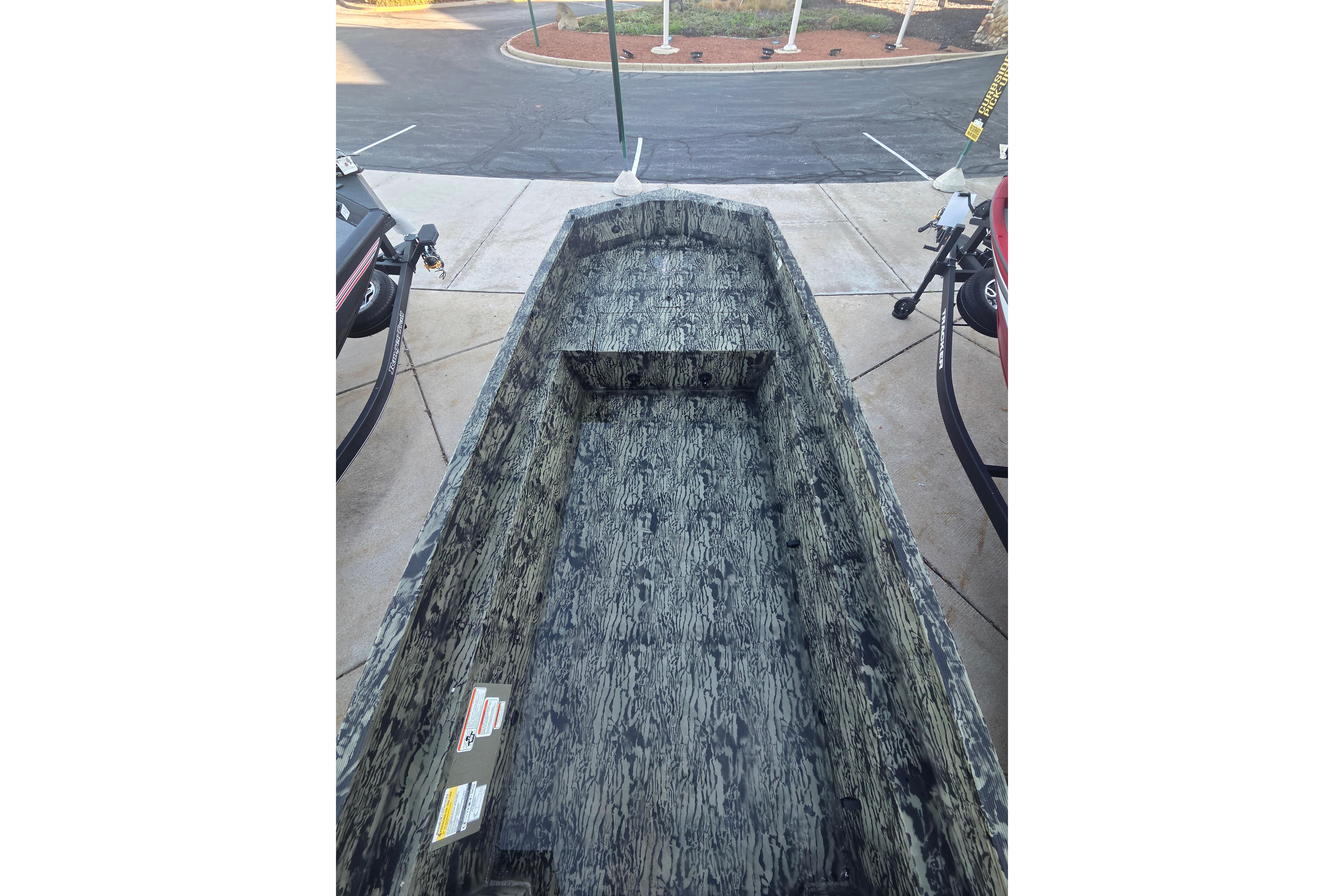 2026 Tracker Grizzly 1650 T Prairie Wings Edition boat with camouflage interior design.