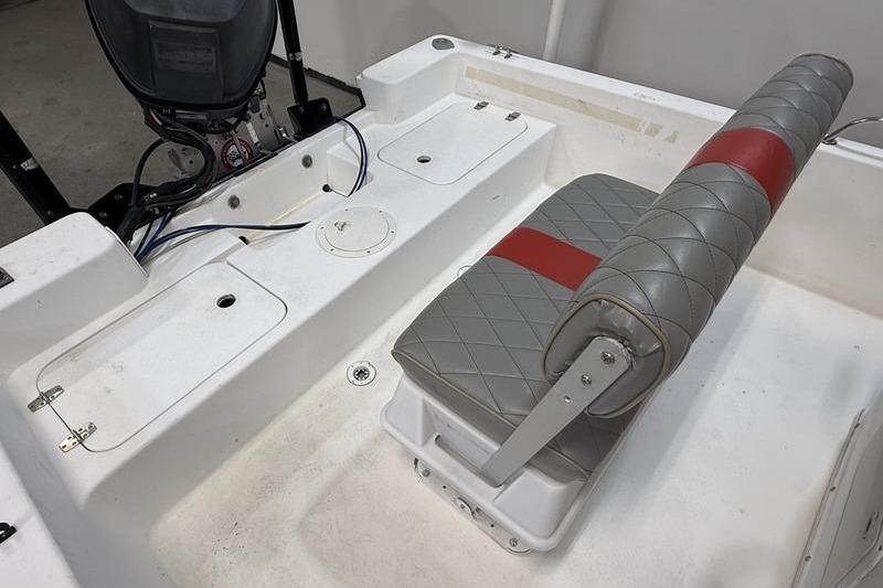 1996 Century 1800 Center Console boat interior with gray and red seating.