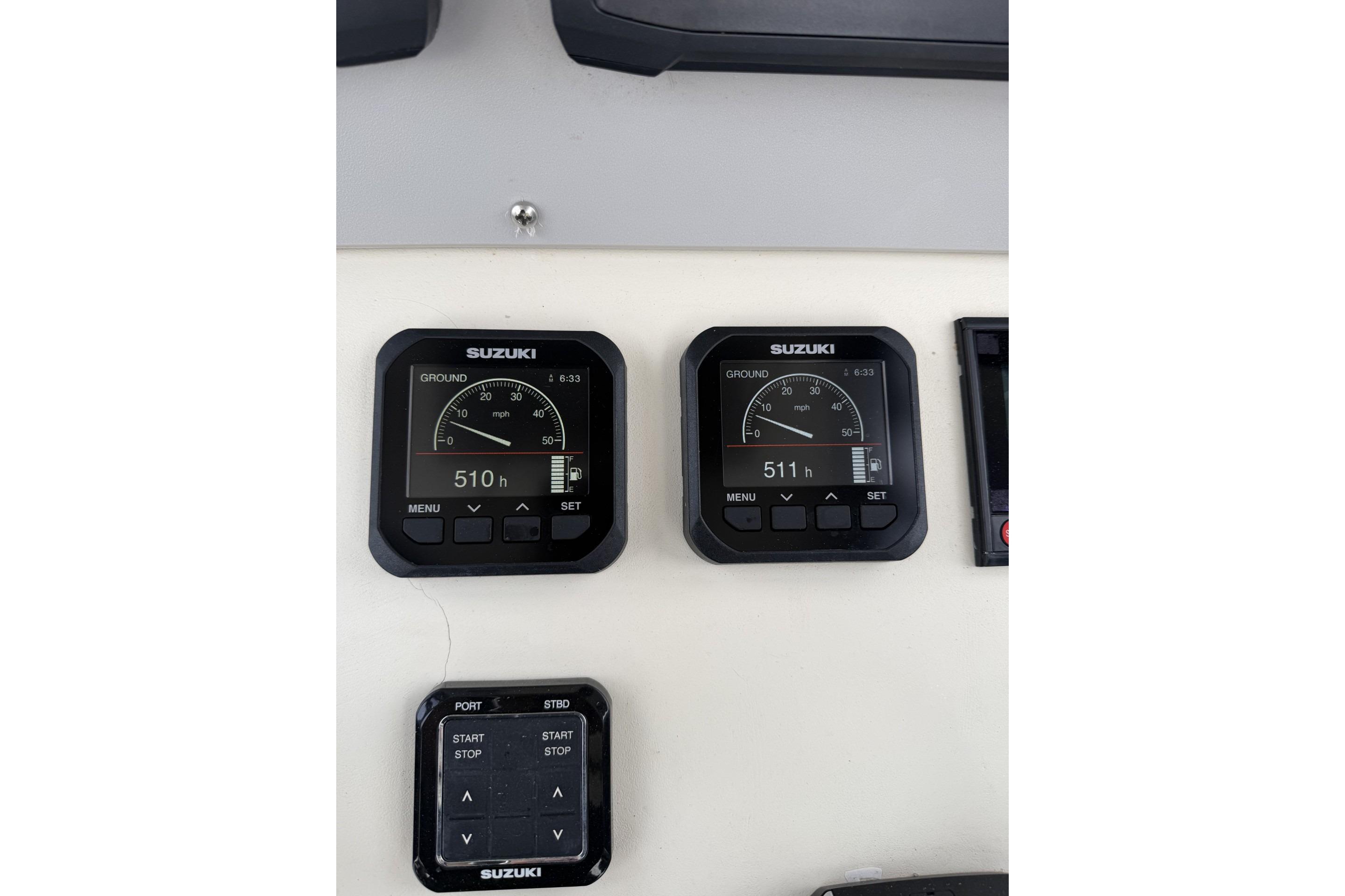 Suzuki gauges on a 1999 Parker 2501 Center Console boat dashboard.