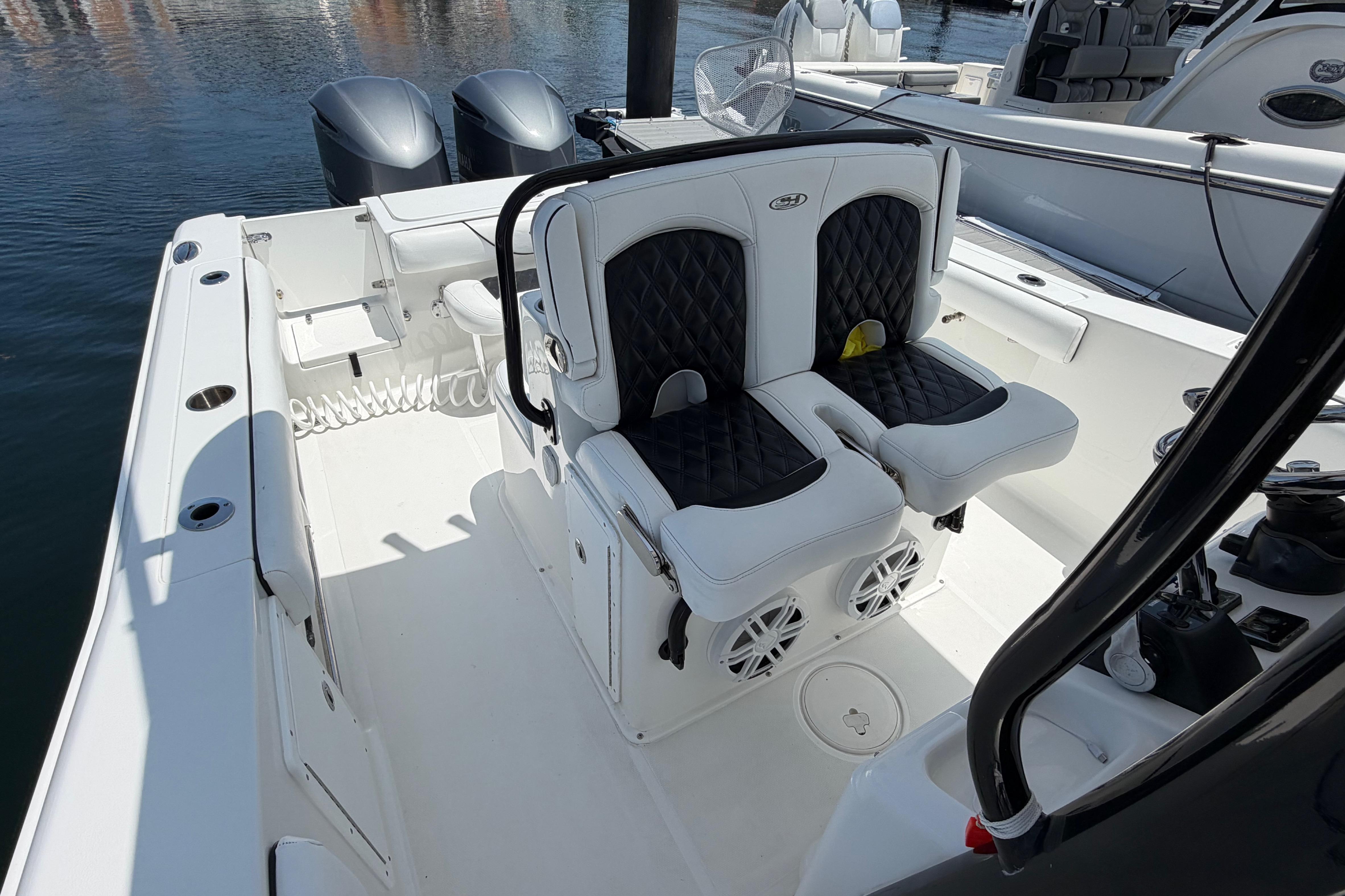 2019 Sea Hunt Gamefish 27 Coffin Box boat interior with dual seats and twin engines.
