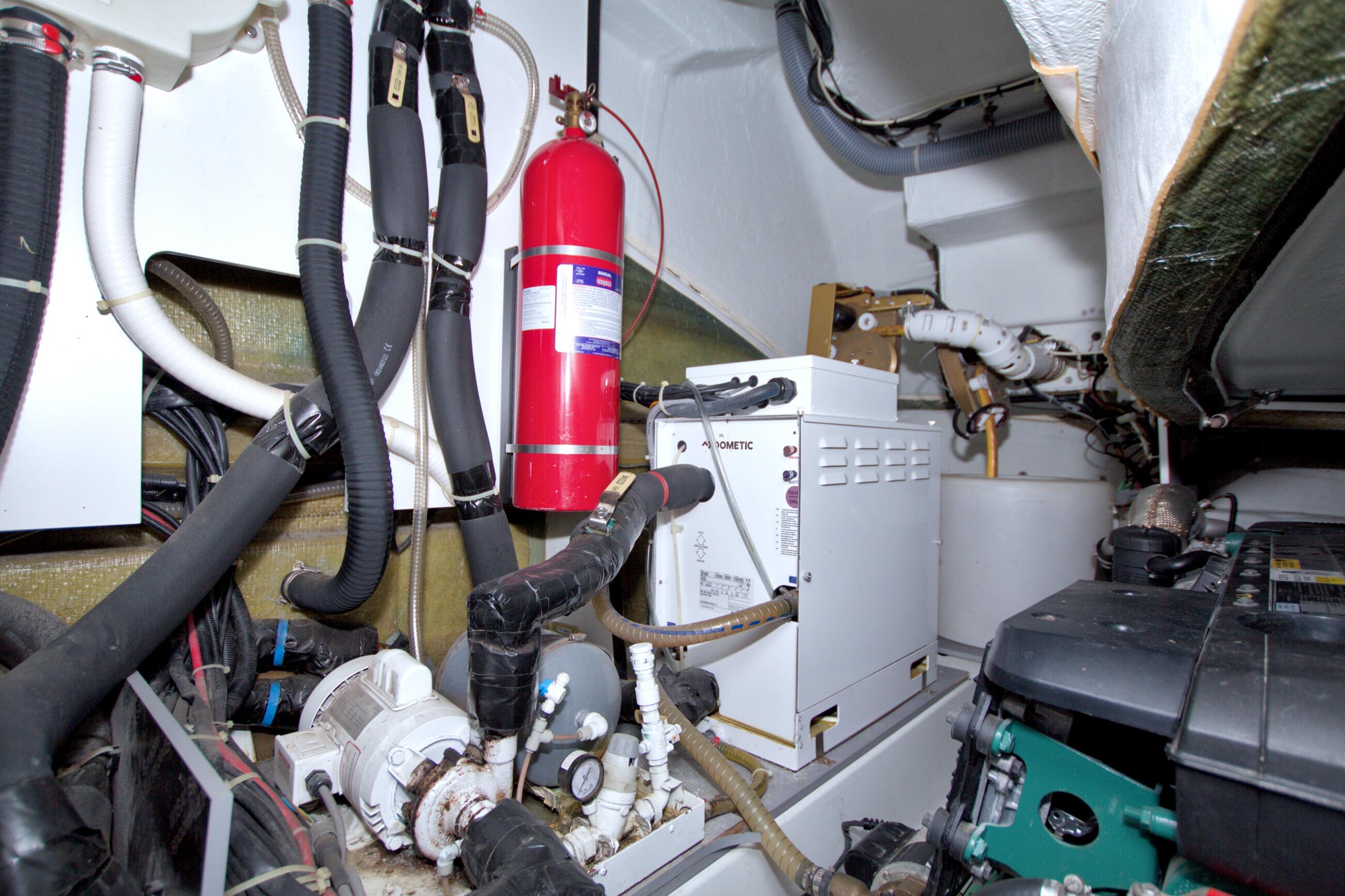 Engine room of 2019 Beneteau Gran Turismo 50 with equipment and fire extinguisher.