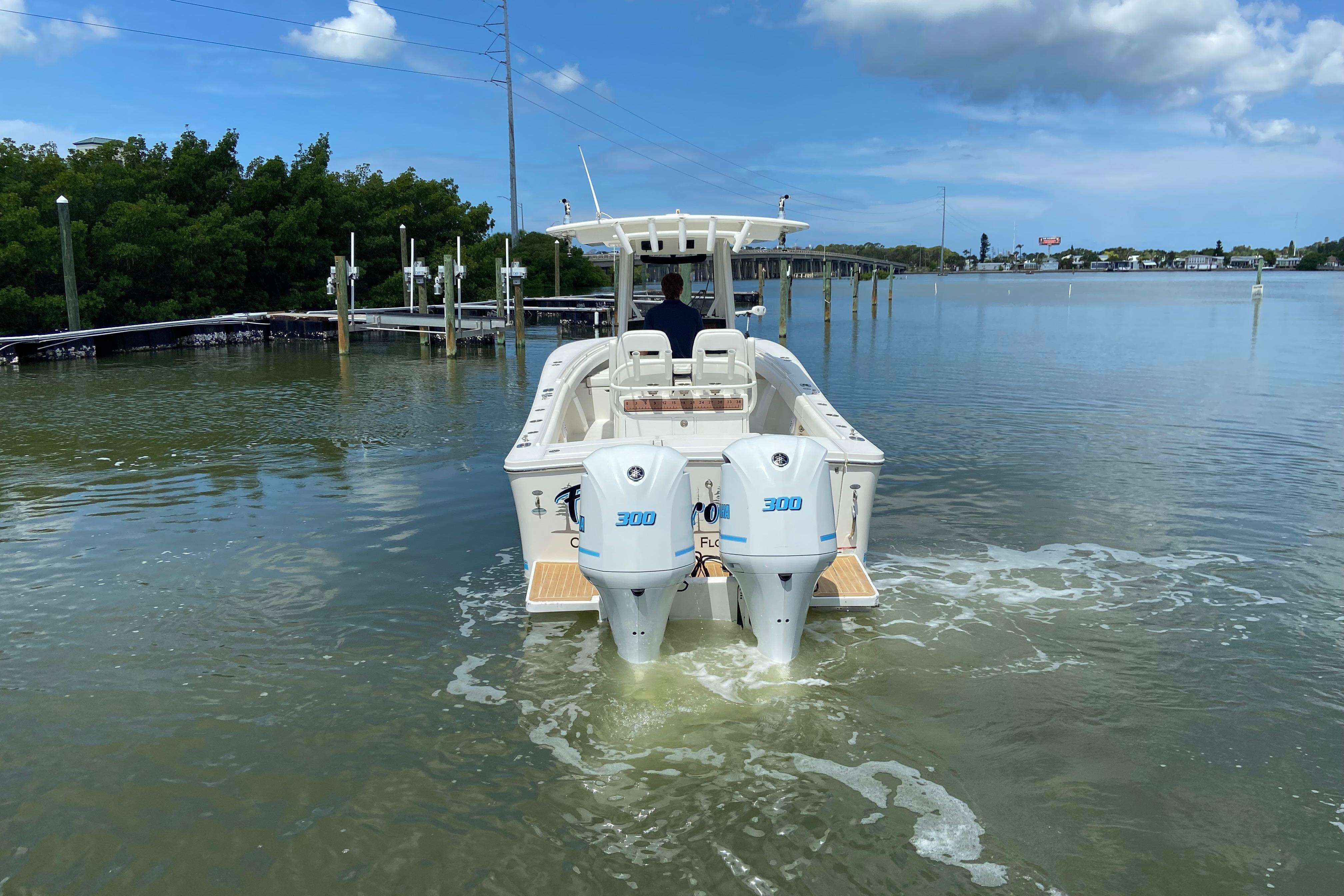 2021 Regulator 28 boat with dual 300 horsepower engines on calm water.