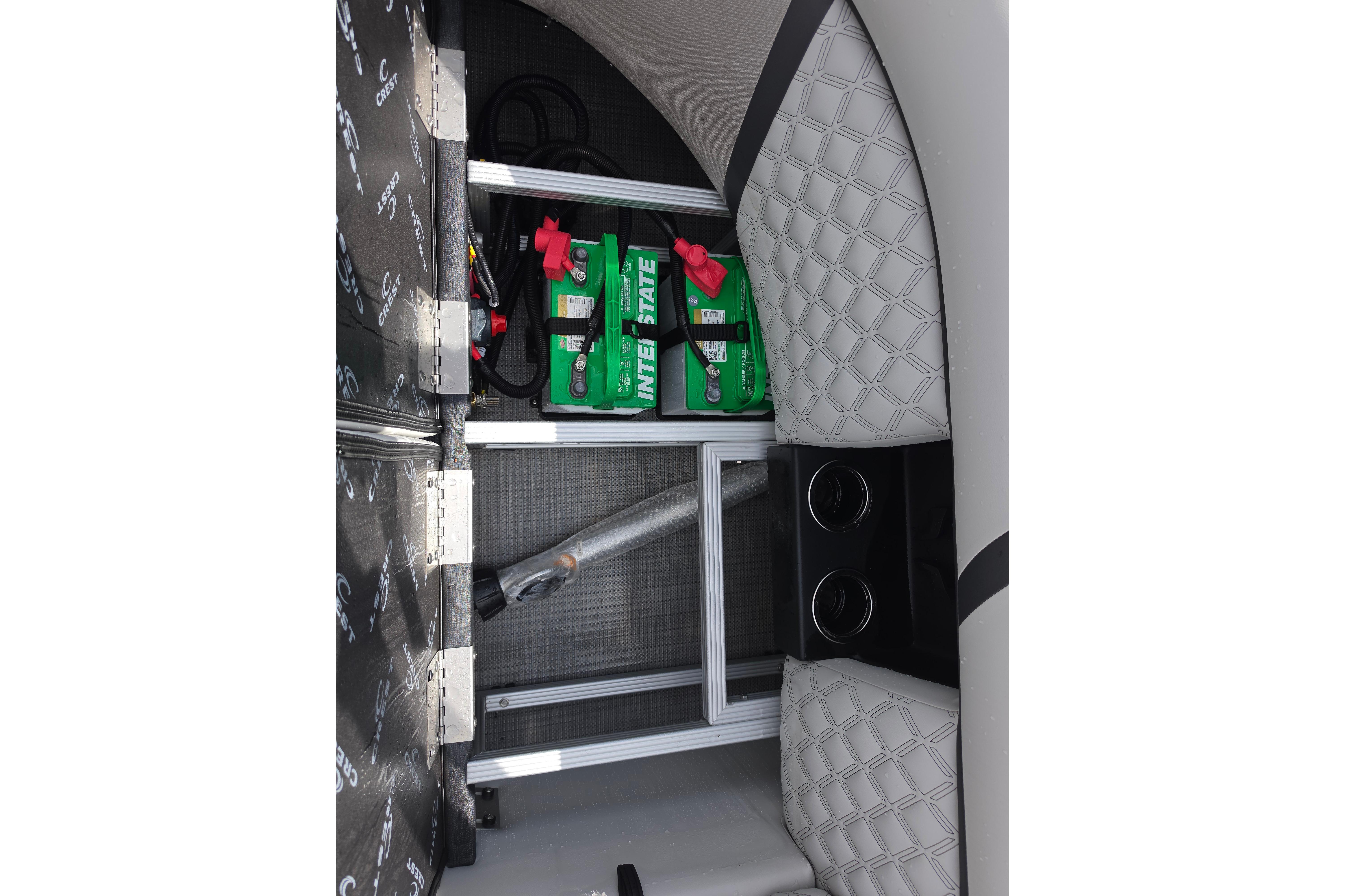 Interior view of 2026 Crest 235 Conquest SLC boat with battery storage compartment.