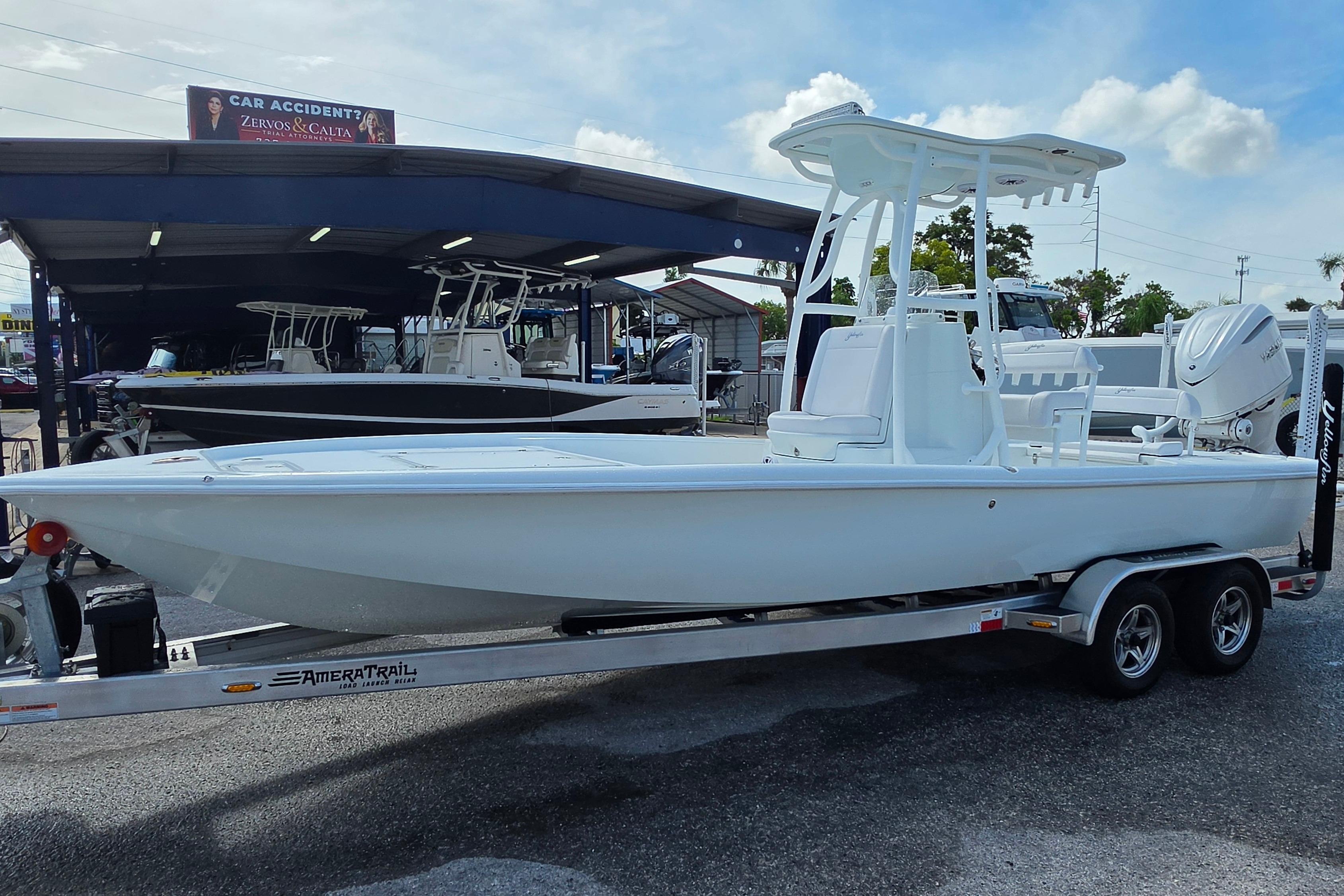 2026 Yellowfin 24 Bay CE boat on trailer at dealership, under clear sky.