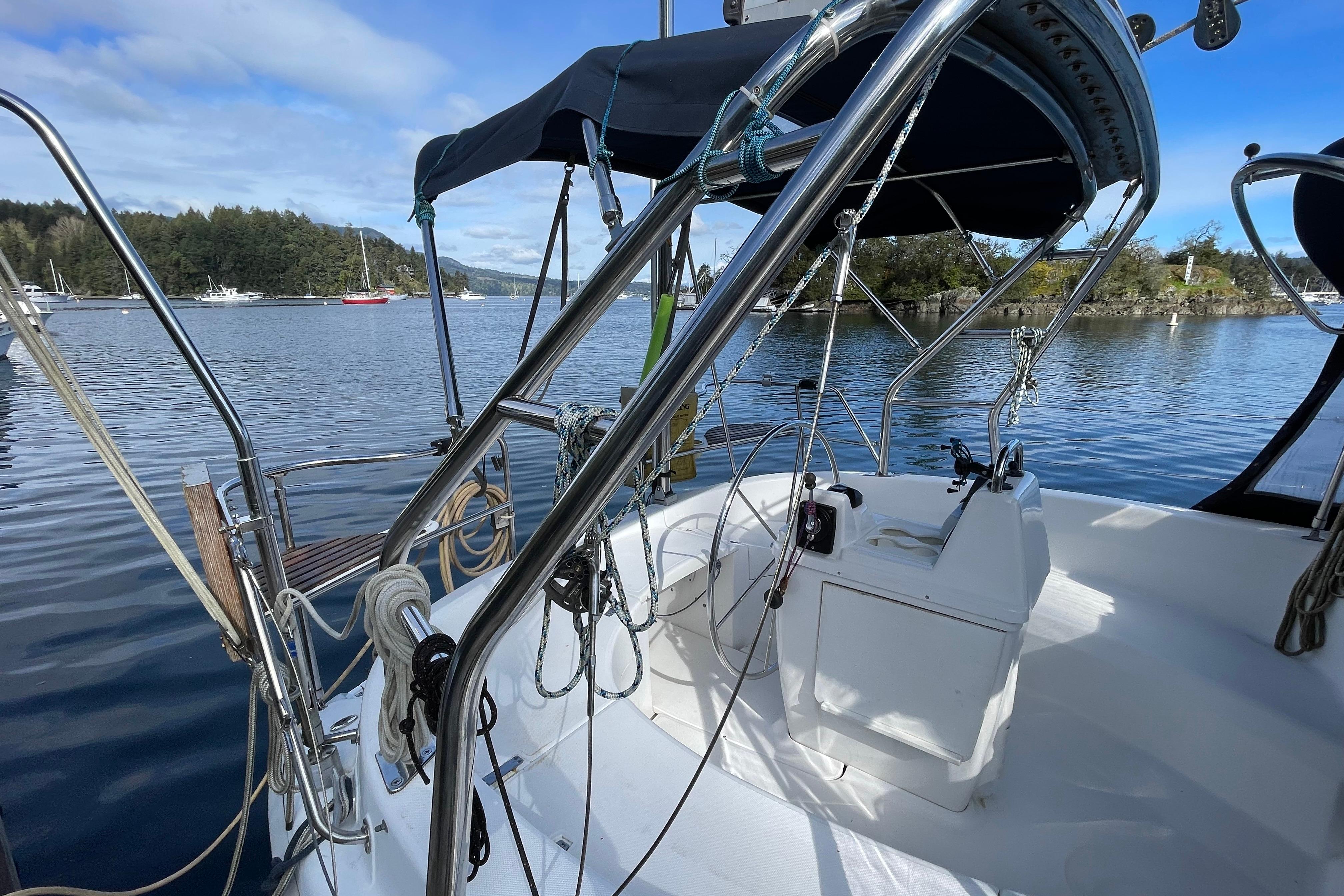 Sailboat cockpit view, Hunter 340, 2000 model, moored on a calm lake.