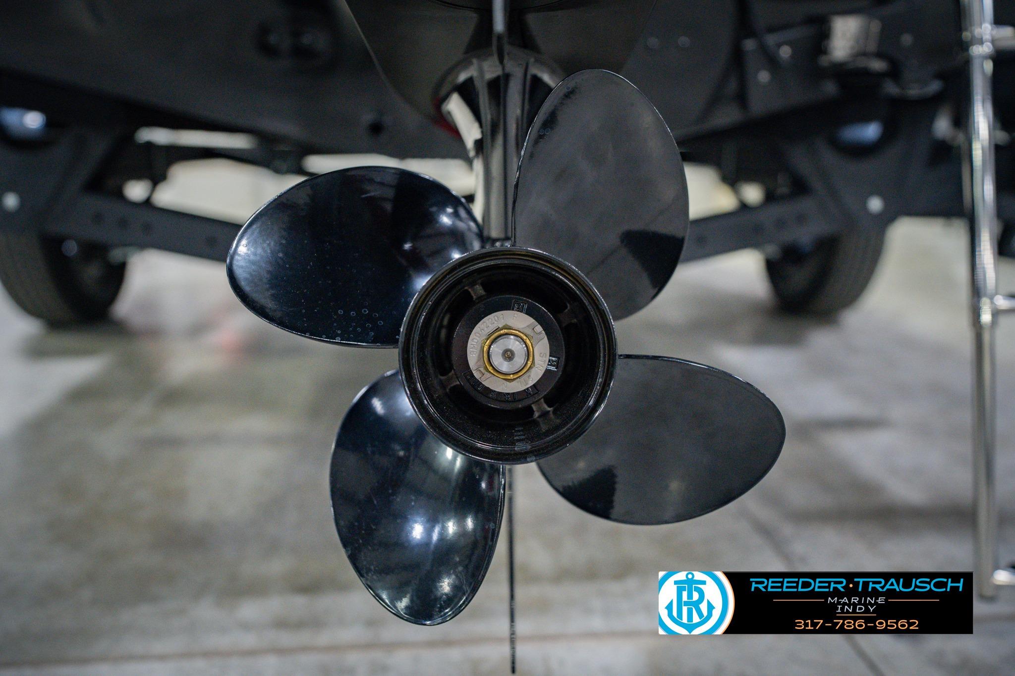 Close-up of a 2026 Lund 1775 Impact XS boat propeller in a showroom.