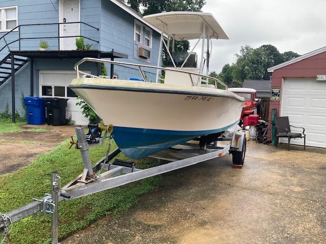 1995 KenCraft Challenger 190 boat on trailer in residential driveway.