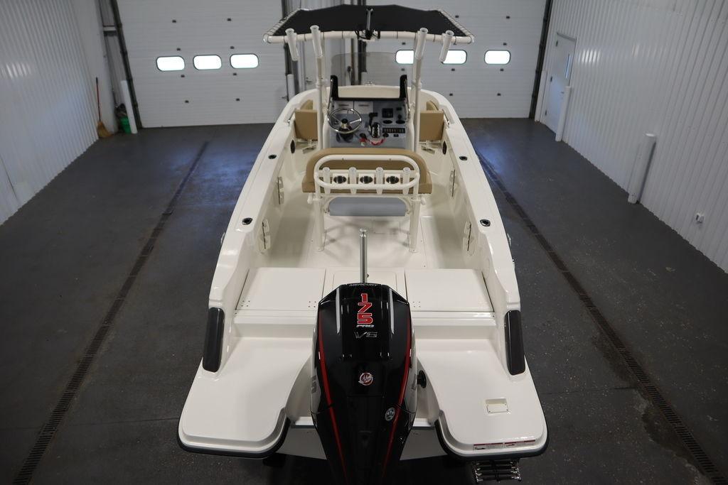2026 Bayliner Trophy T20CC boat in a garage, showcasing interior and outboard motor.
